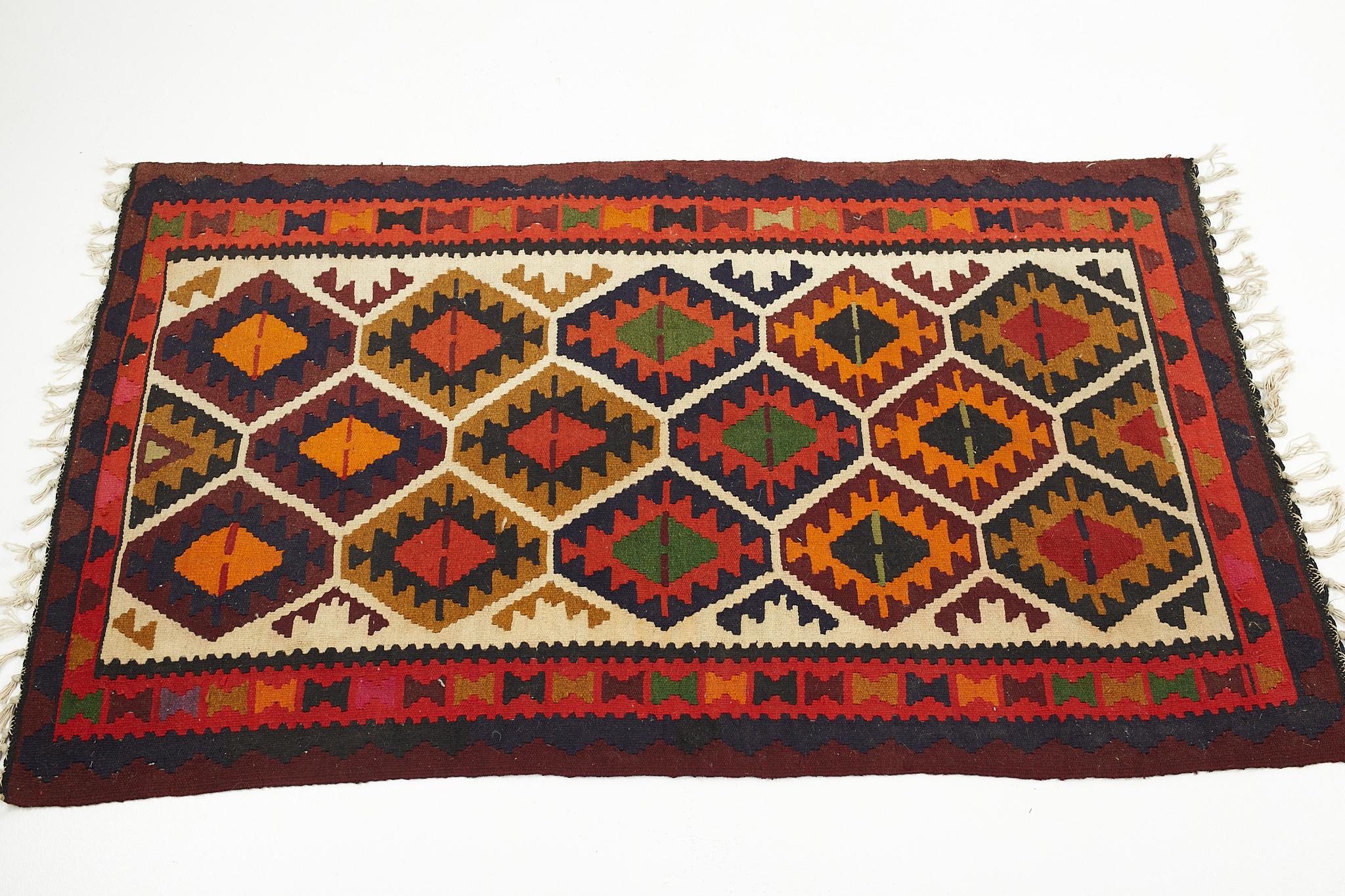 Mid century multicolored southwest motif flatweave wool rug

The rug measures: 67 wide x 38.5 inches deep 

We take our photos in a controlled lighting studio to show as much detail as possible. We do not photoshop out blemishes. 

We keep you