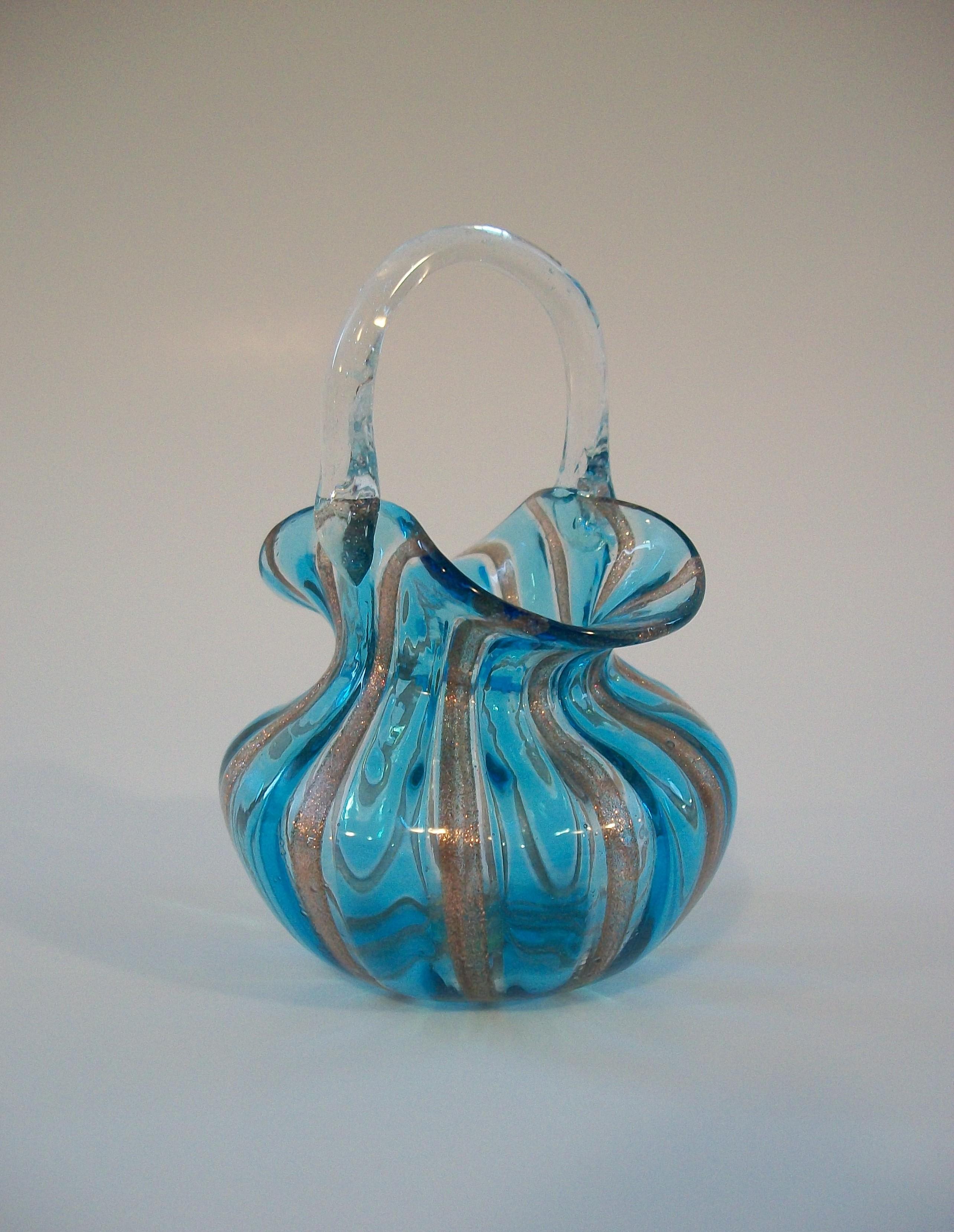 Mid Century Murano art glass basket - featuring copper aventurine canes and blue glass with a clear glass handle - small size - light weight with a polished finish - original retail label to the base - unsigned - Italy - circa 1950's.

Excellent