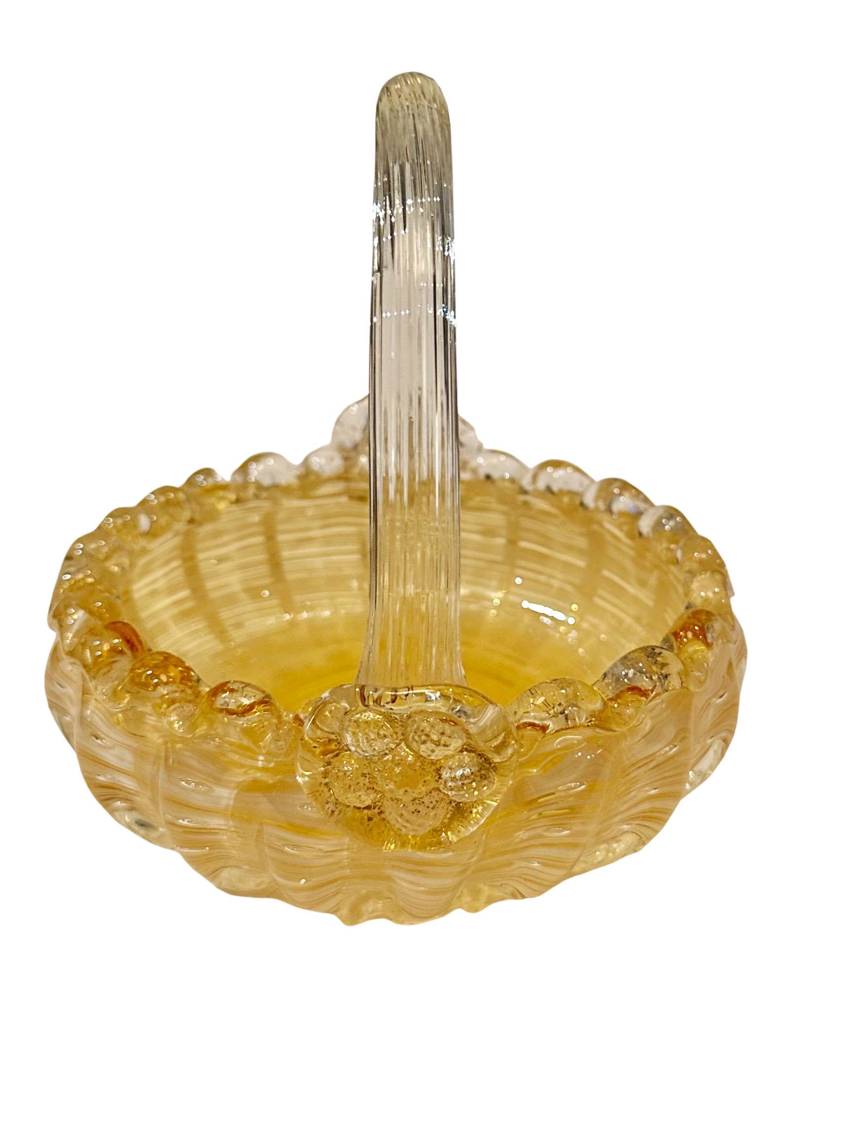Murano glass basket candy dish. Cinched at the edges to make a ruffled edge. Beautiful yellow with a transparent handle. This will be sure to delight your guest. Circa 1950s, Italy.
