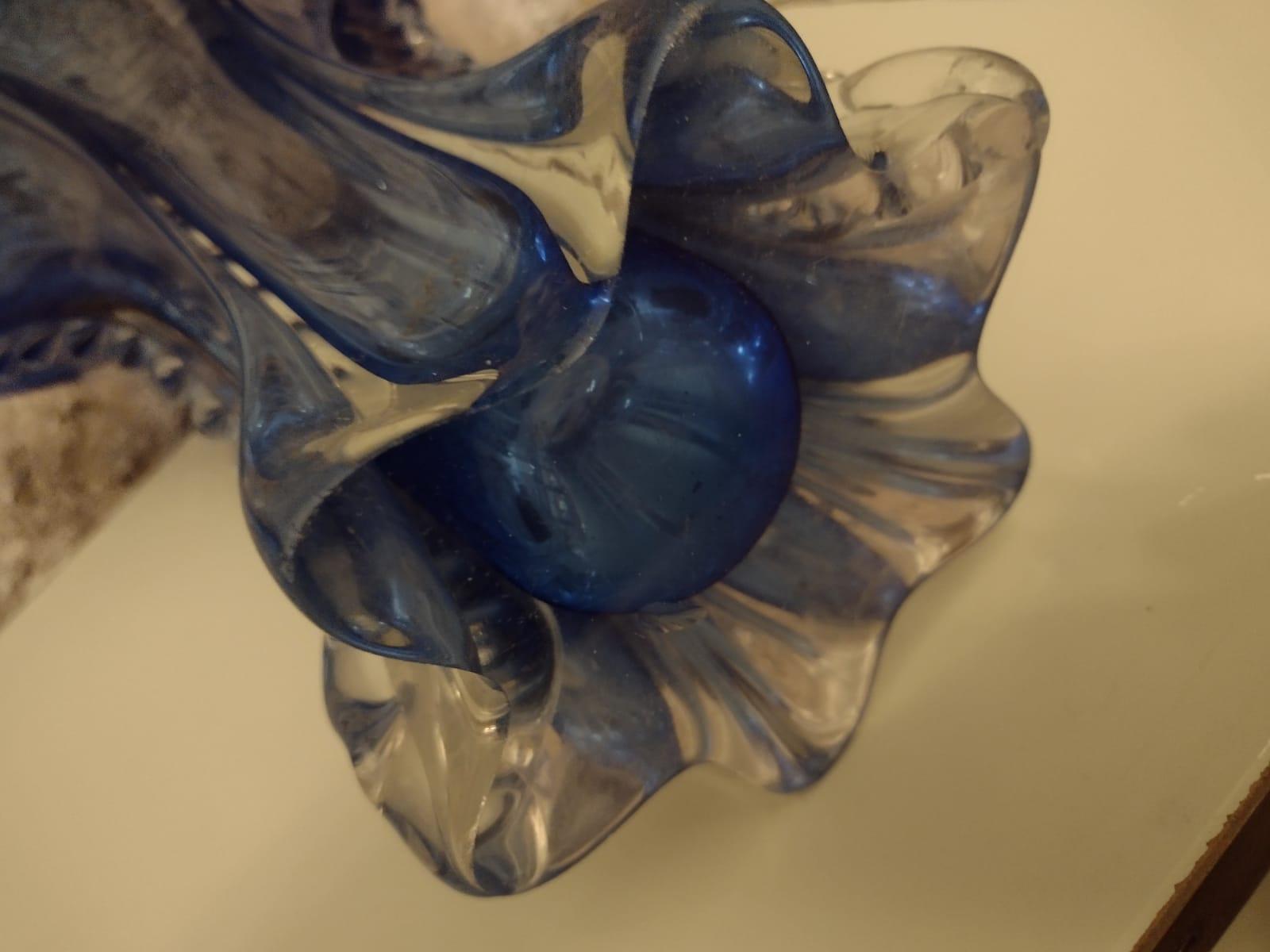 Beutiful mid century Murano glass vase from the renown glass art workshops in Italy. Artfully made in the period around 1950 this fantastic shaped glass vase shows a lovely coloration in a clear glass and deep blue tone. A decorative piece of Murano
