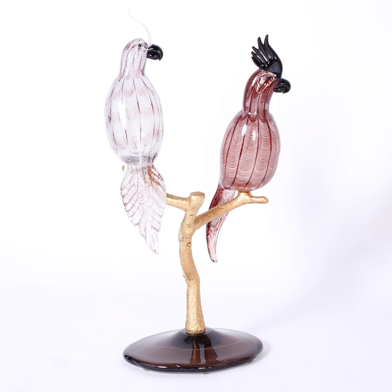 Midcentury sculpture depicting two hand blown cockatoos perched on a doré bronze tree on a glass base signed Zanetti.