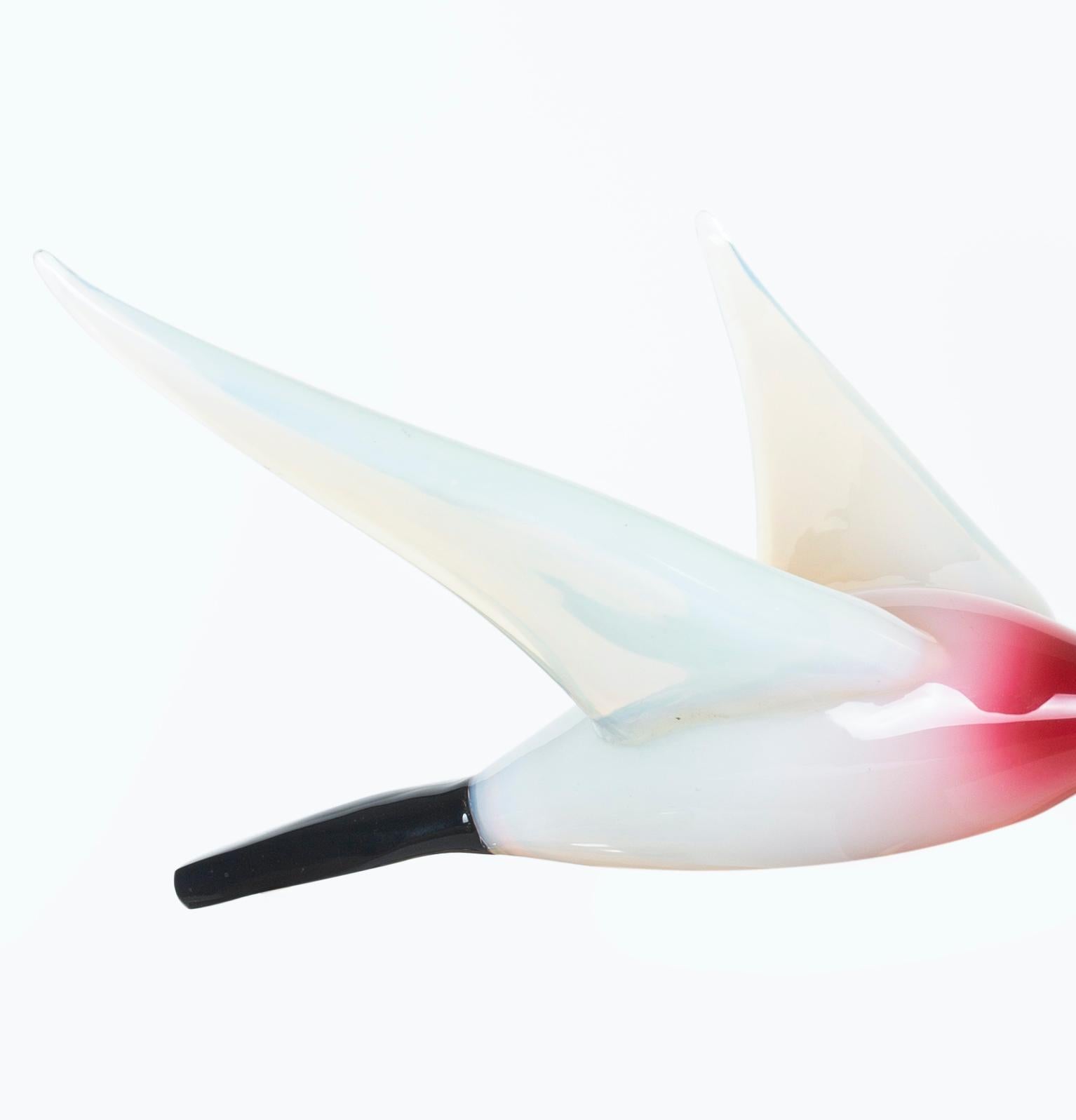 Midcentury Murano glass bird is a beautiful glass decorative object, realized by Murano manufacture probably during the 1970s.

This contemporary object is a beautiful hand blown Murano glass bird. Made of multiple colors including pink, black and