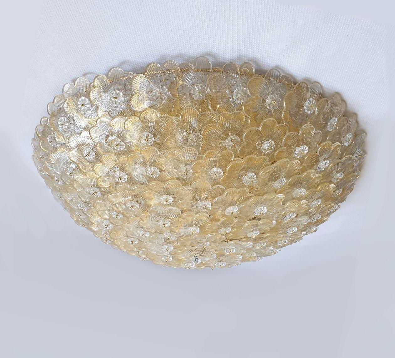 Large mid century modern flush mount chandelier, by Barovier, Italy 1970s.
Two flush-mounts available: sold and priced individually.
The chandelier is made of gold and clear Murano glass flowers, over a round gold painted metal grid frame.
Each