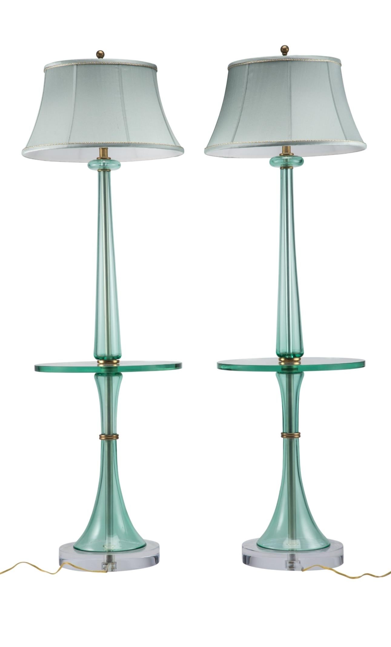 A fabulous pair of rare one-of-a-kind vintage Italian Murano art glass floor lamps by Marbro Lamp Company. 

Mid-Century Modern, fine quality, featuring an elegant sculptural silhouette, with integral circular floating glass shelf - tray table,