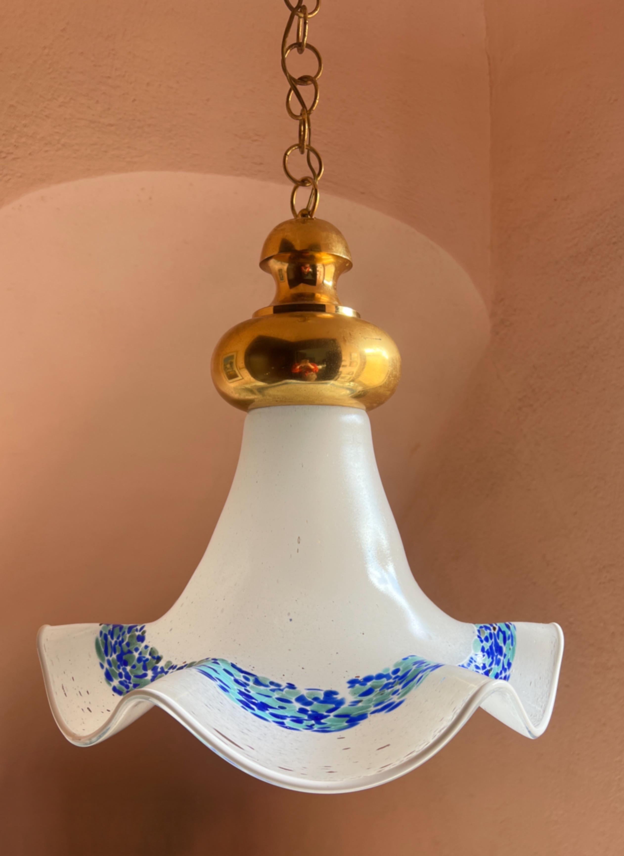This exquisite Murano glass pendant light was crafted by La Murrina in the 1970s. The elegant bell-shaped silhouette echoes the form of a softly blooming flower with a base in milky white glass accented by delicate irregular clear spots. 

A