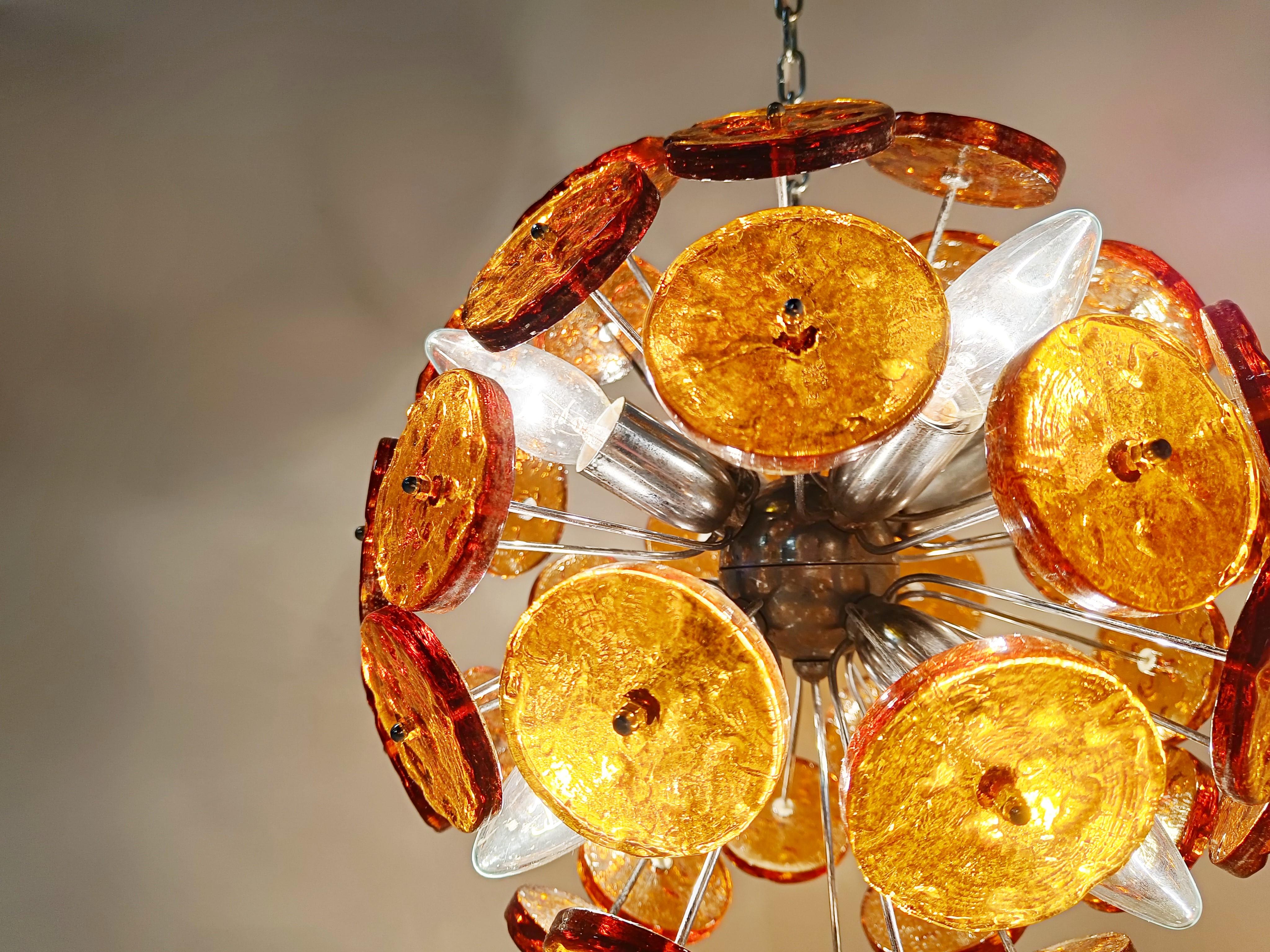 Striking sputnik shaped chandelier with brown/amber coloured murano glass discs mounted on a chrome frame.

Once illuminated, this beautiful chandelier emits a warm diffuse light.

Tested and ready to use.

We can change the chain lenght if