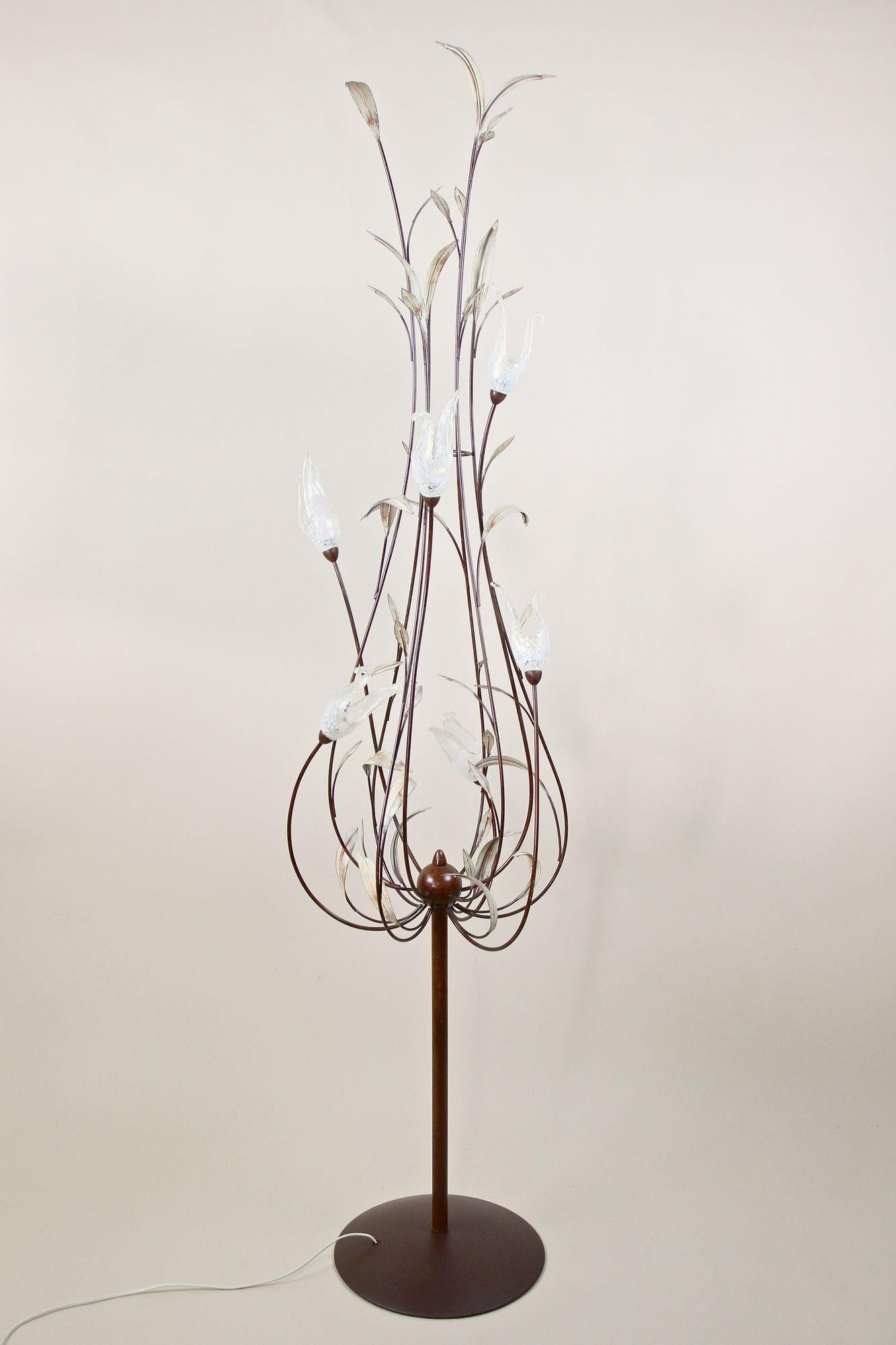 Magical midcentury Murano floor lamp from the period around 1970 in Italy. An extraordinary, absolutely fantastic shaped large metal floor lamp showing beautiful hand painted reed leaves. The highlight are the six stylized Murano glass swans which
