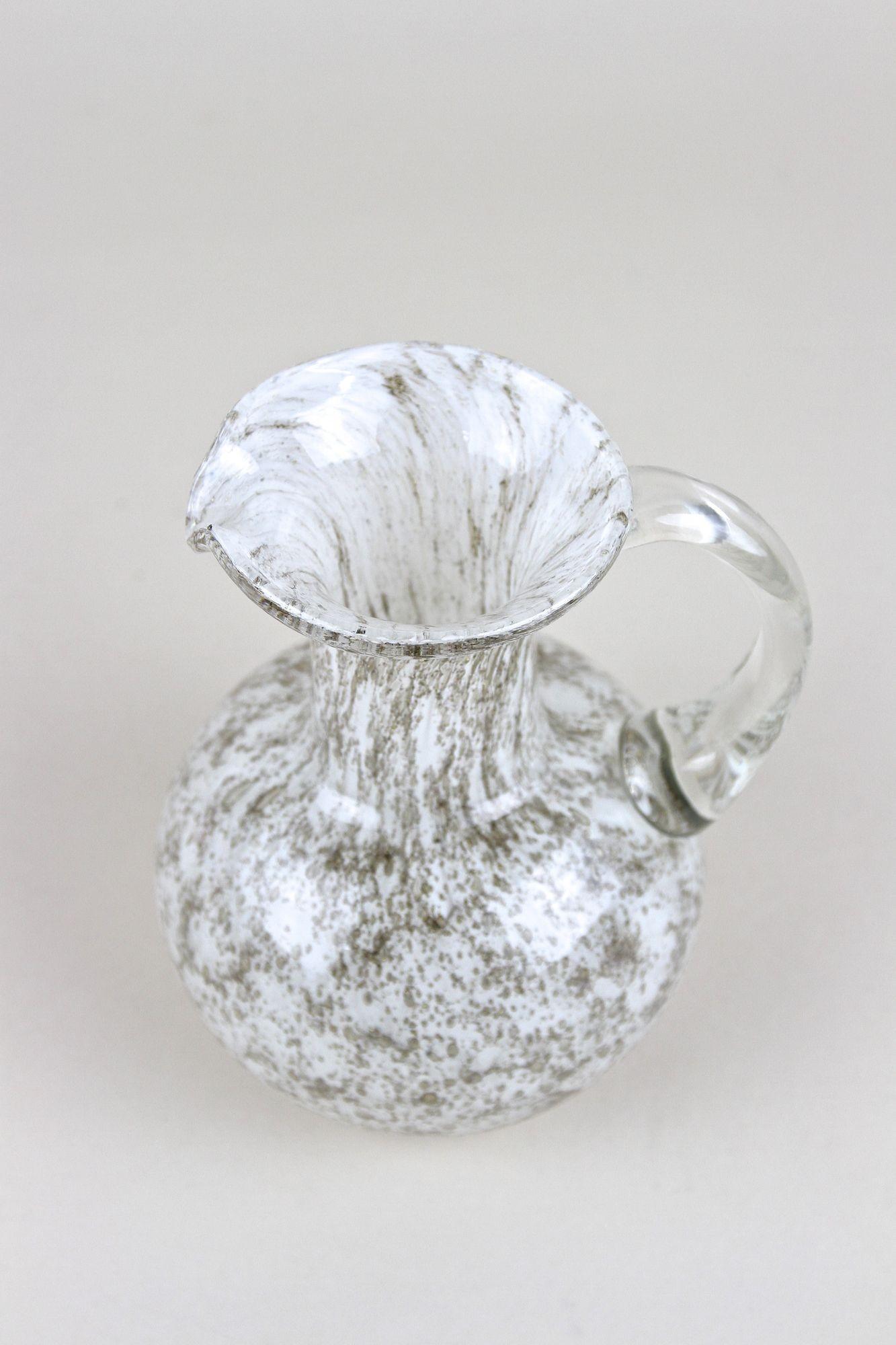 Unique designed Murano glass jug/ glass vase out of the famous workshops in Italy from the mid 20th century around 1960. This wonderful shaped jug was handcrafted in a special technique showing hundreds of little air bubbles captured in the glass