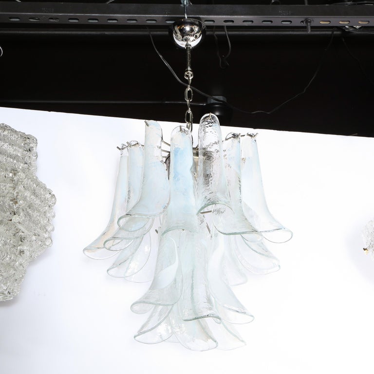 This sophisticated Mid-Century Modern feather chandelier was realized in Murano, Italy- the island off the coast of Venice renowned for centuries for its superlative glass production- circa 1970 by the esteemed atelier of Mazzega. It features two
