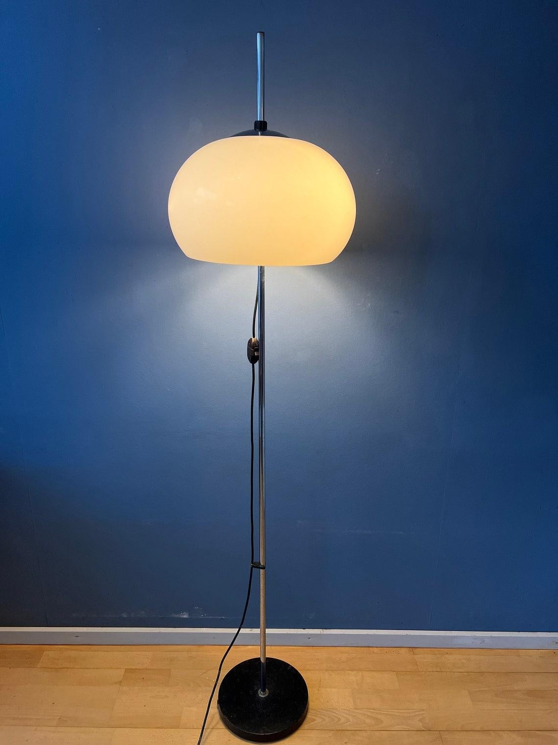 Mid century mushroom floor lamp with white acrylic glass shade. The shade can be moved up and down the base. The lamp requires two E27/26 lightbulbs and currently has a EU-plug.

Additional information:
Materials: Metal, plastic
Period: