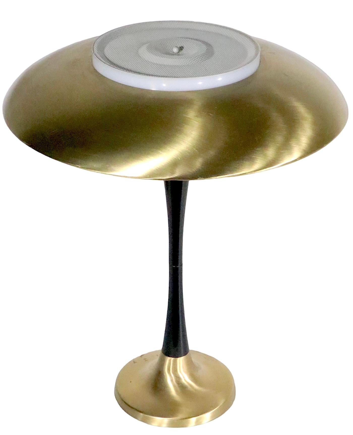 Chic architectural Mid Century dome top table lamp, attributed to Gerald Thurston, for Lightolier - circa 1950/1960's. The lamp features a circular domed top shade, which rests on a center post with an interior plastic diffuser. The vertical post is