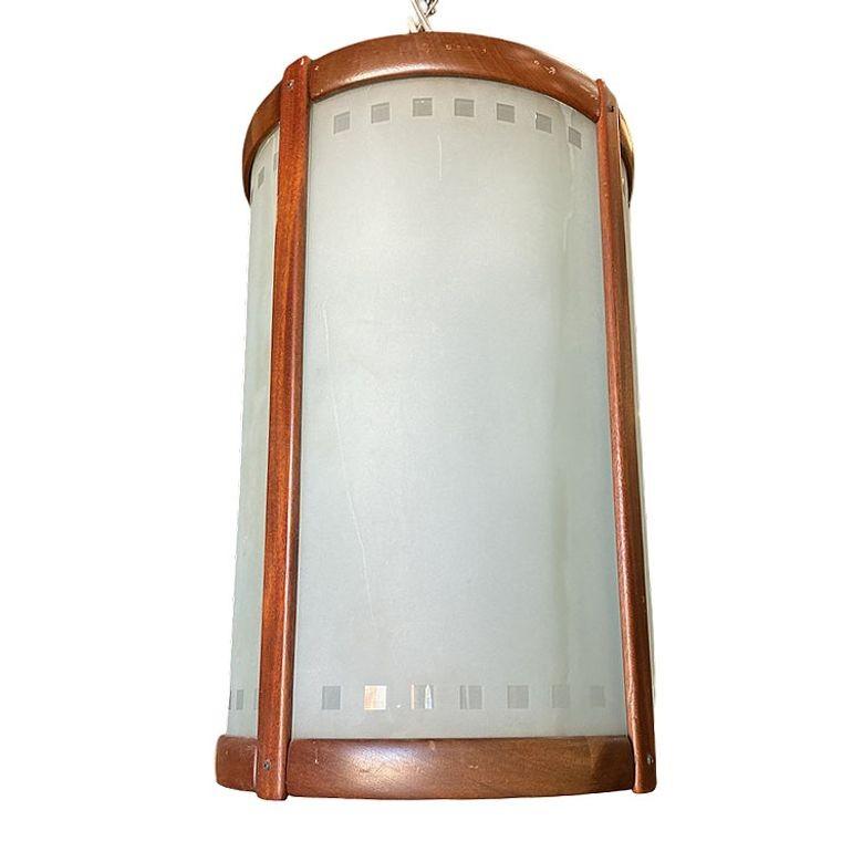 Mid-Century teak cylinder pendant light chandelier with frosted glass shade featuring a geometric pattern along the edge. This is a very heavily constructed light fixture, more than likely from a department store in Los Angeles. The lamp takes