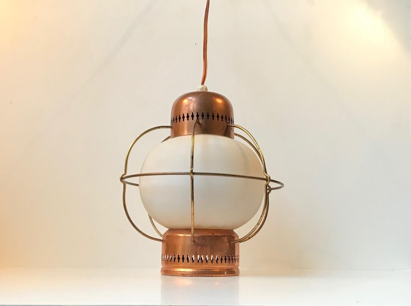 - A vintage maritime pendant lamp
- Made of copper, brass, opaline glass and caged in brass wire
- It was manufactured by Lyfa in Denmark during the 1960s
- The design may have been executed by Bent Karlby. But this remains uncatalogued.