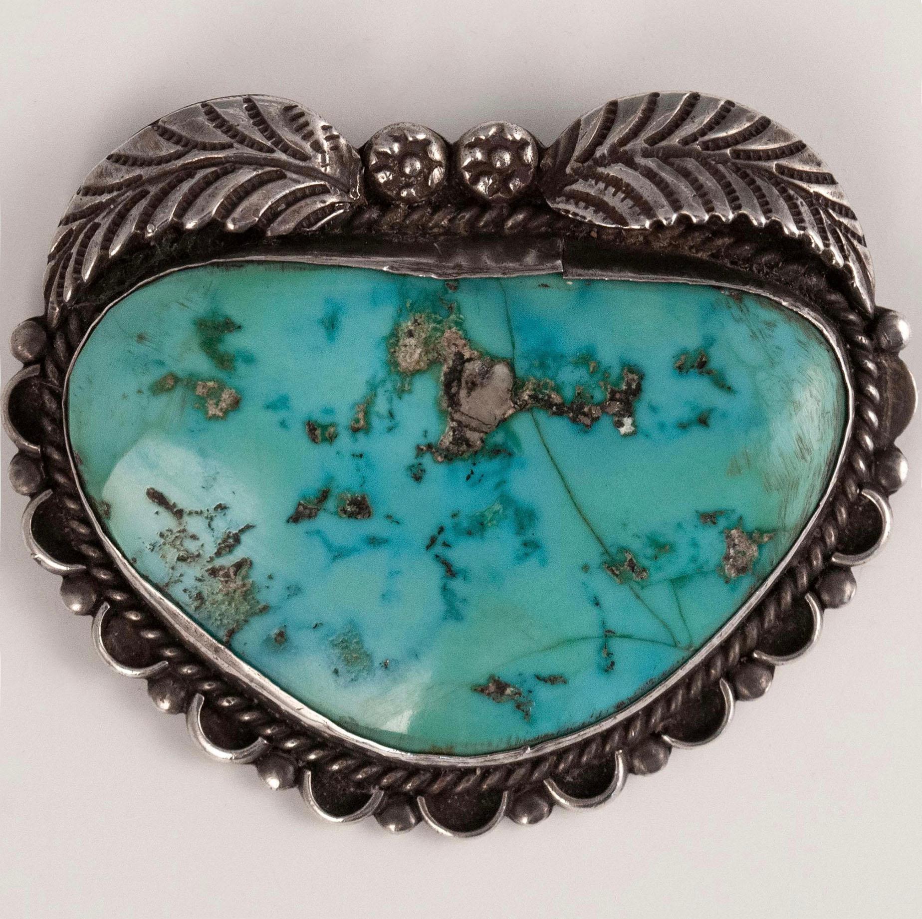 Mid-Century Navajo Silversmith T. K. Turquoise and Silver Brooch

A large gorgeous old turquoise stone set in an almost heart-shaped brooch by a Navajo silversmith with initials T.K., as stamped verso. It measures 2 by 2.5 inches. 44 grams.


