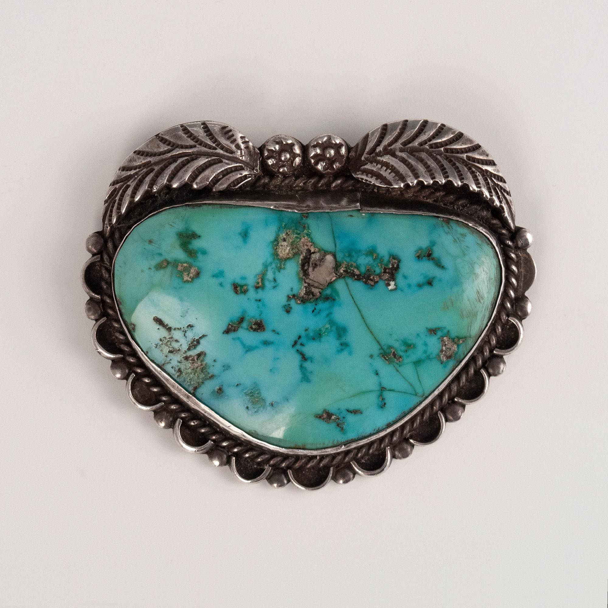 Mid-century Navajo silversmith T. K. Turquoise and silver brooch

A large gorgeous old turquoise stone set in an almost heart-shaped brooch by a Navajo silversmith with initials T.K., as marked verso. 2 by 2.5 inches. 44 grams.
    