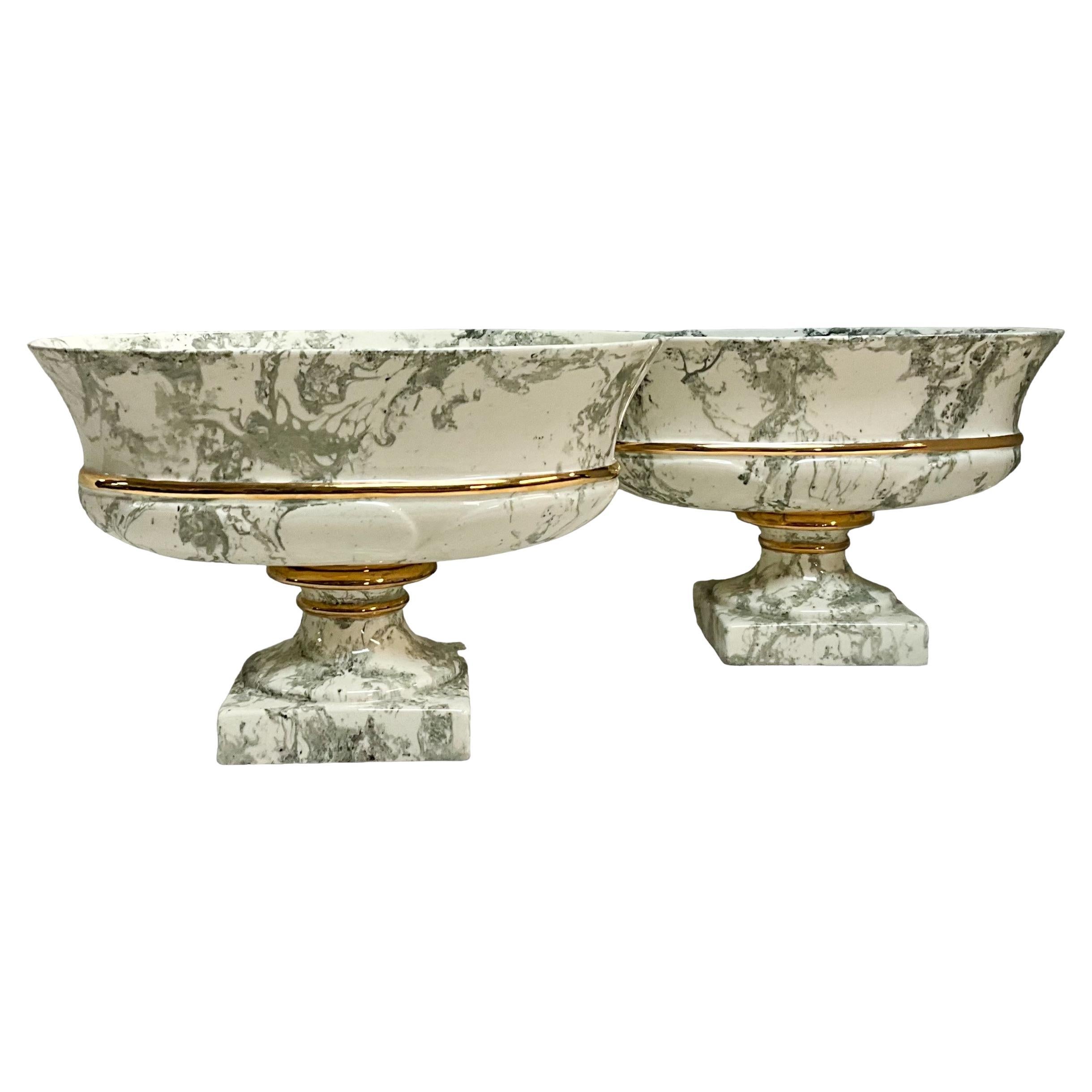 This is a lovely set of faux marbleized ceramic planters with gilt accents. They are ivory with great veins. They are unmarked.  