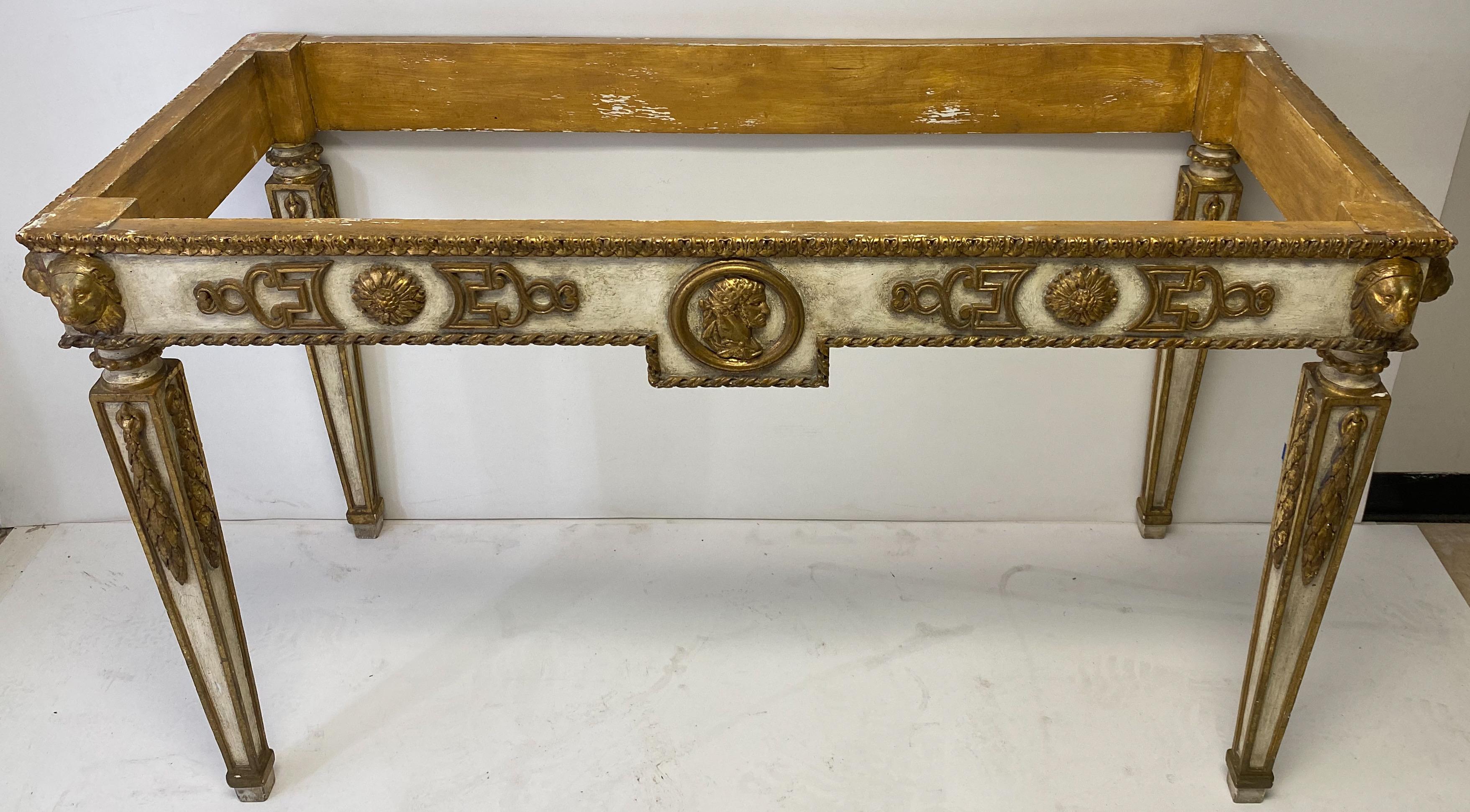 This is a midcentury Italian neoclassical style marble-top console table. The Italian marble is not attached and does appear to be original. The heavily carved frame is painted with an ivory base and gilt accents. It is unmarked.