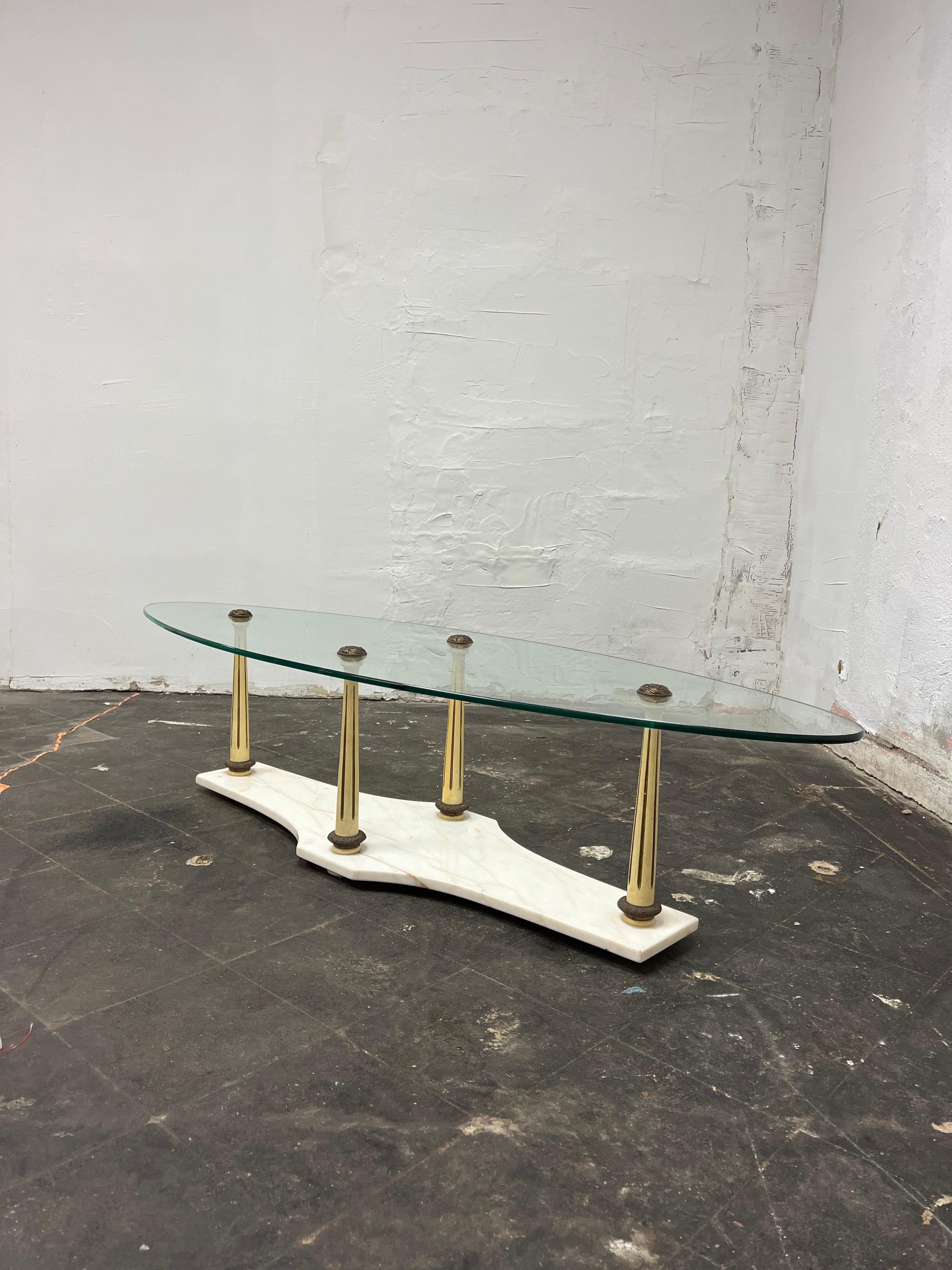 Vintage oblong glass coffee table on marble base. 4 wood fluted columns with decorative metal caps to secure. Screams 1950's elegance. A great hollywood regency, neoclassical representation.
Curbside