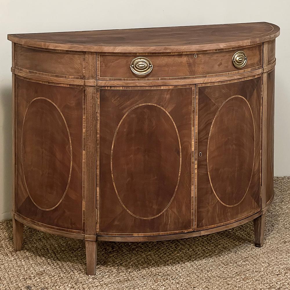 Mid-Century Neoclassical Revival Demilune Mahogany Cabinet ~ Console ~ Buffet was hand-crafted by talented artisans in a semi circular form creating a piece that is the most traffic-friendly casework you can own!  Possessing no corners at all, its