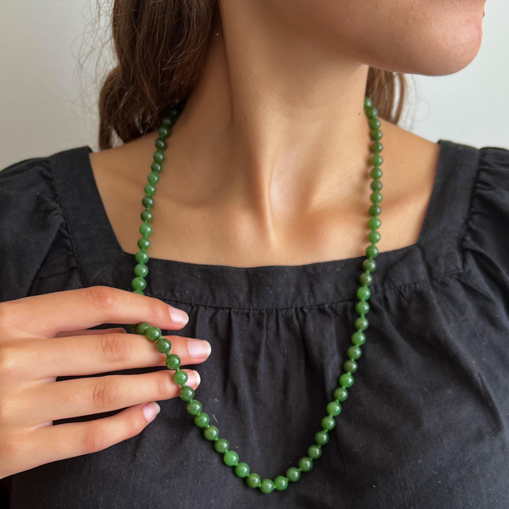 This vintage green nephrite jade beaded necklace is made of one single-strand. The length of the necklace is long and consists of round-shaped nephrite jade stones. These jade beads have a very nice green color and are equally sized. To keep some