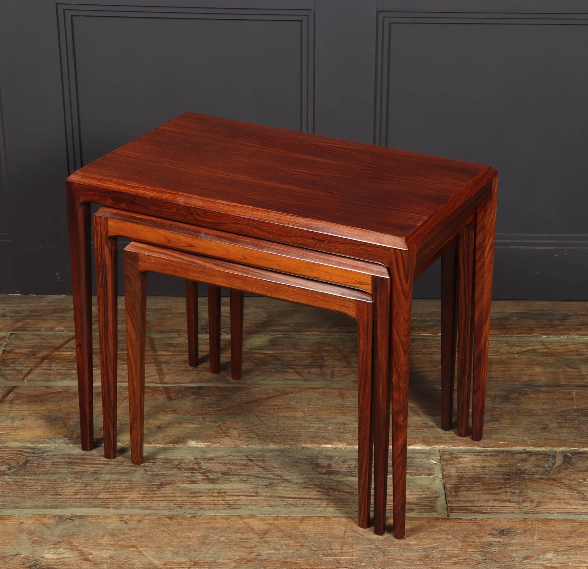 A set of three nesting tables in santos rosewood designed by Johannes Andersen and produced by Silkeborg in Denmark around the middle of the 1960s, they are of exceptional quality with tapered octagonal leg and chamfered top the nest bears makers