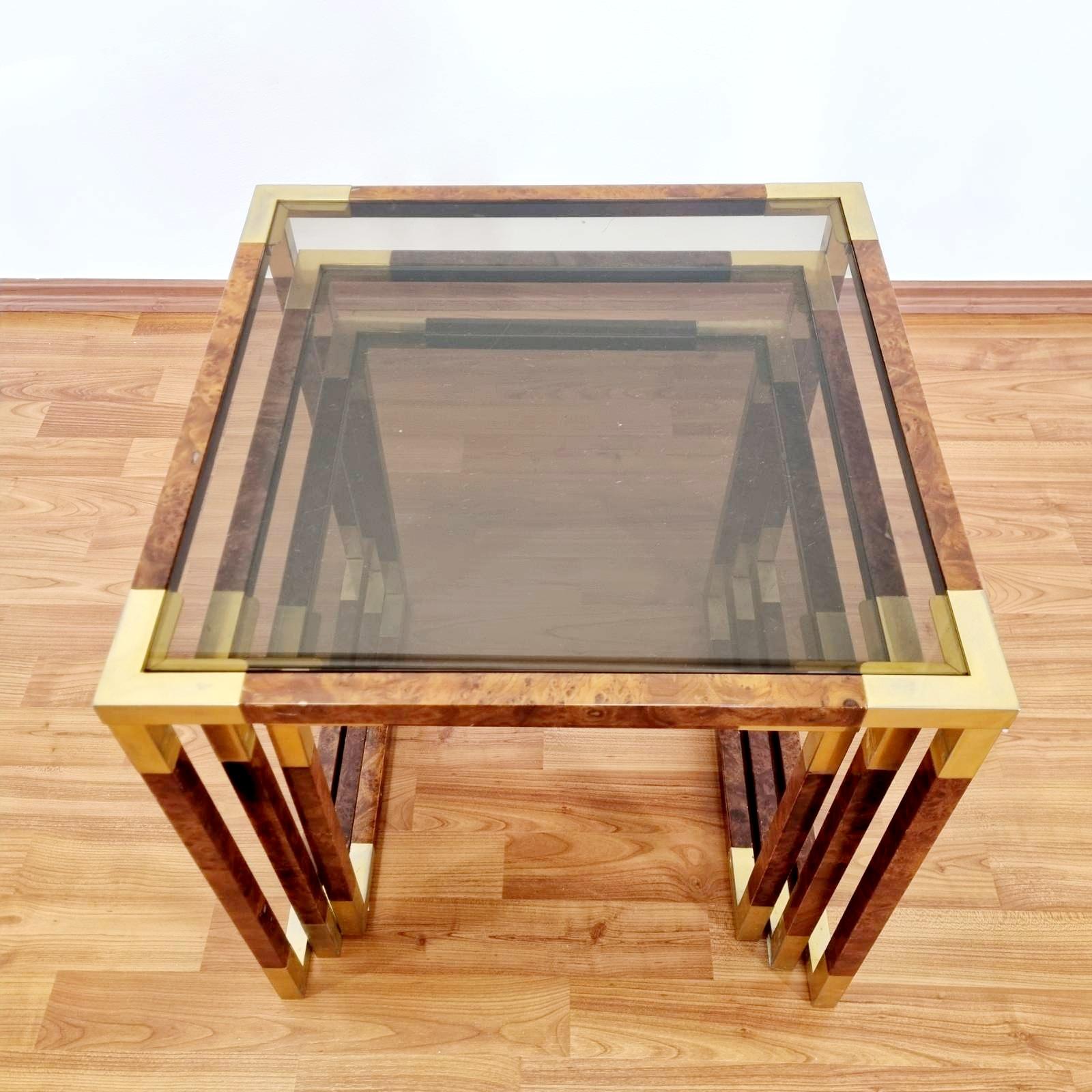 Set of 3 brass, glass and briar root nesting coffee or end tables. Made in Italy in the 1970s.
In very good vintage condition with minor signs of wear on the glass.

Dimensions :
Large table 47x47x47 cm
Medium table 42x42x42 cm
Small table