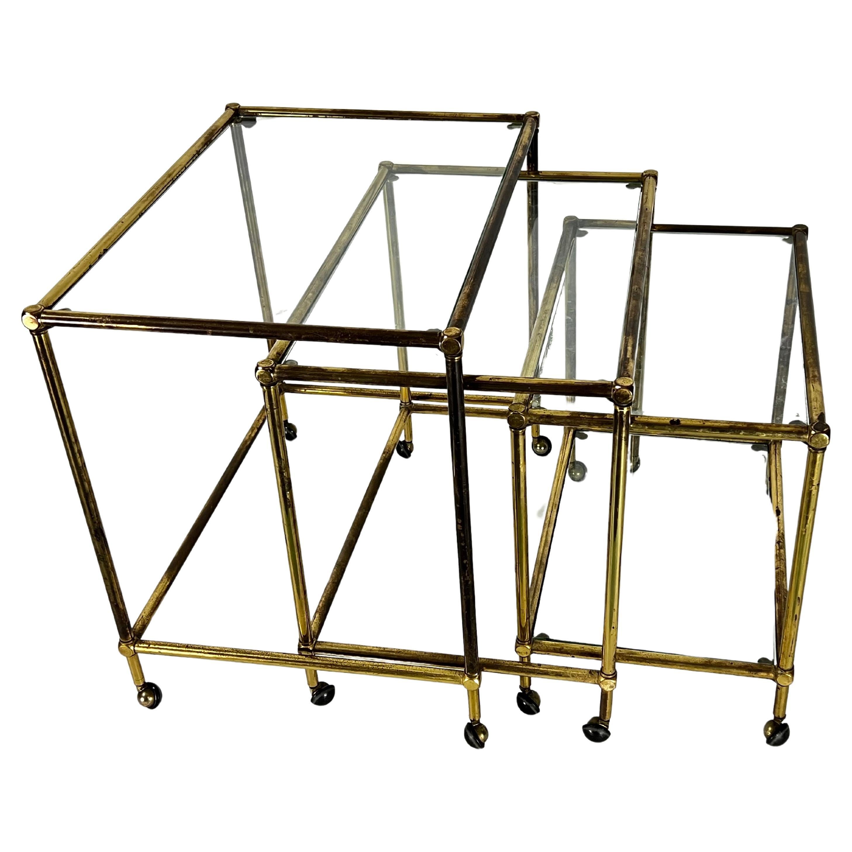 Mid-Century nesting set of three bar carts in brass and glass. Italy 1950s For Sale