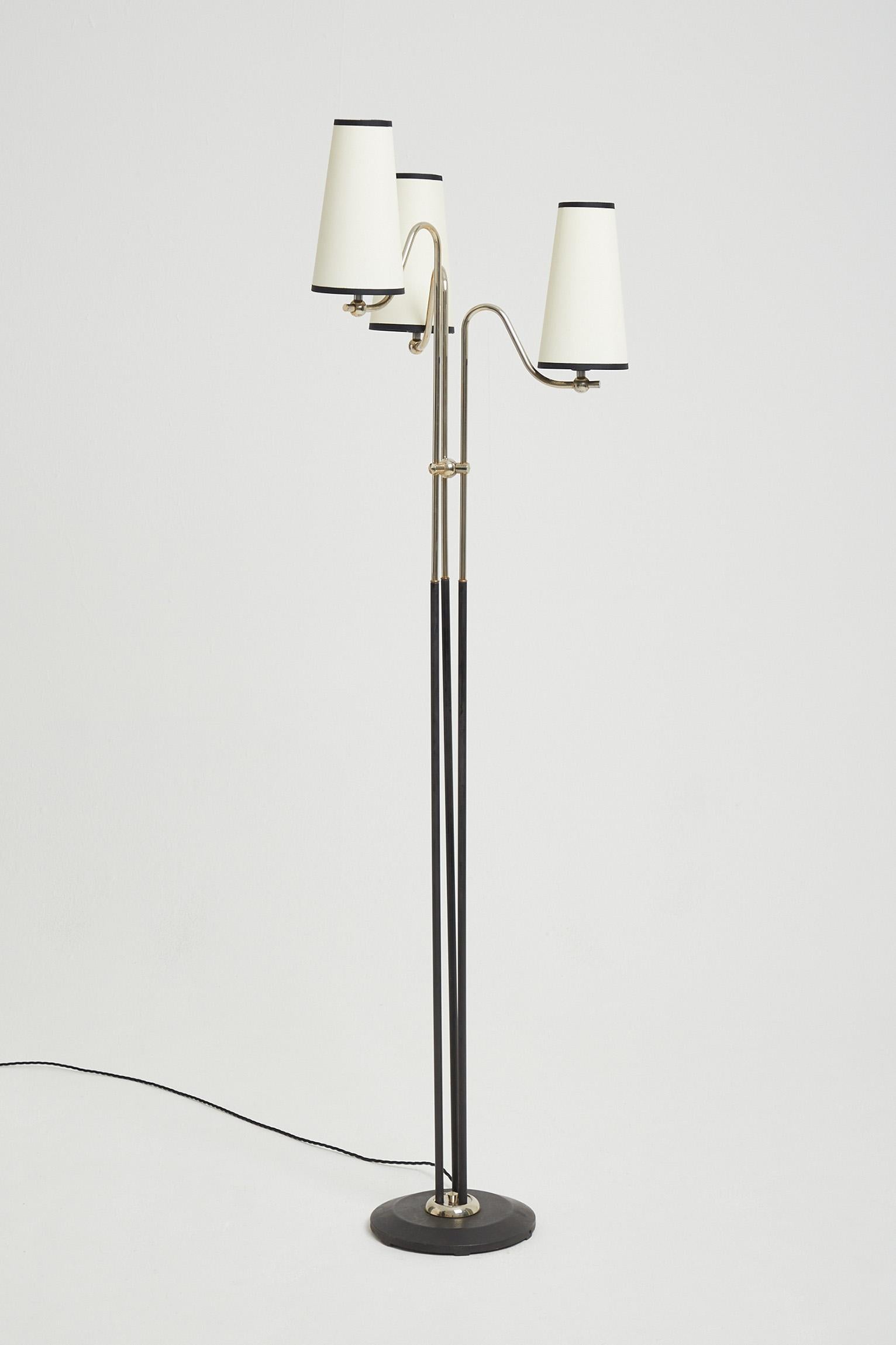 A three light nickel and black iron floor lamp, with bespoke shades.
France, third quarter of the 20th century.
Measures: With the shades: 163 cm high by 47 cm diameter.
Lamp base only: 150 cm high by 25 cm diameter base.
