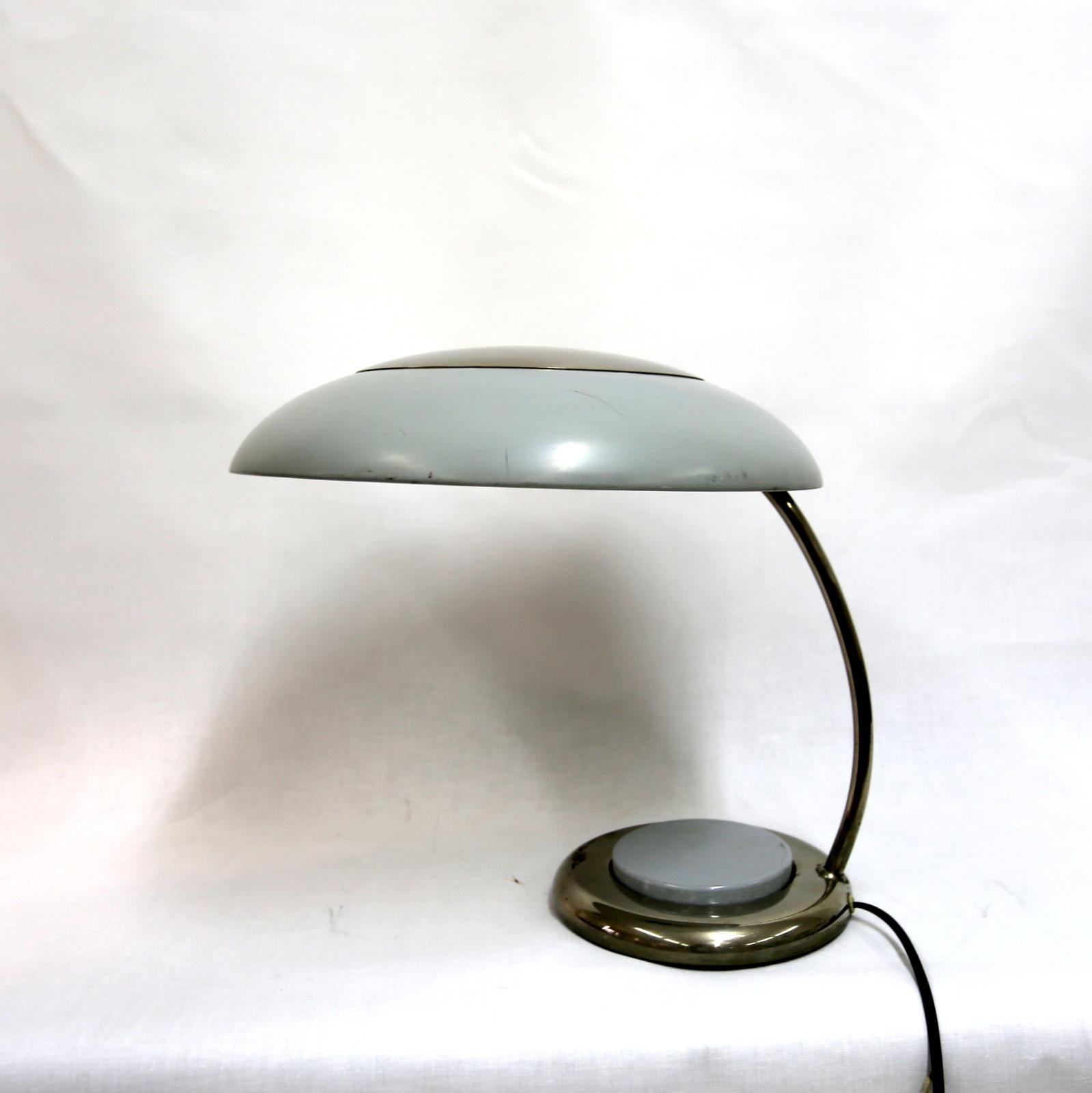 This rare piece is from eastern Europe, from the 1960s- the middle part of the base is actually a push down button, which switches the light on and off.
Electronically restored but in original condition, this nickel plated and painted steel lamp is
