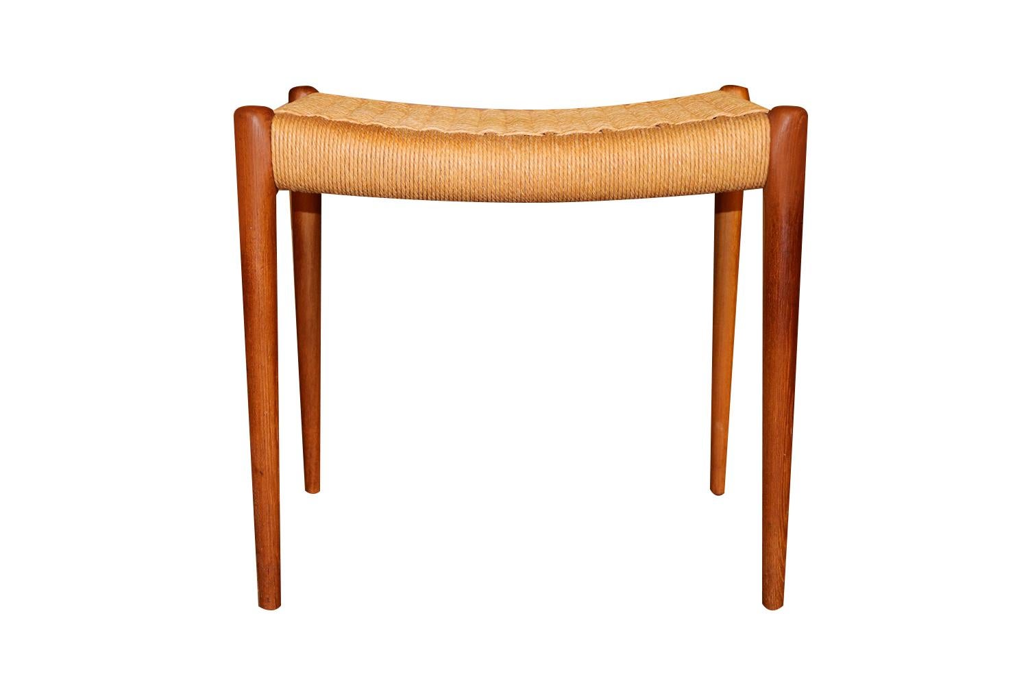 An absolutely stunning teak Danish Cord ottoman, bench model 80A designed in 1963 by Niels Otto Møller for J.L. Møllers Møbelfabrik in Denmark. Makers Stamp (Møller Furniture Maker) underneath ottoman. This gorgeous ottoman, crafted in solid teak,