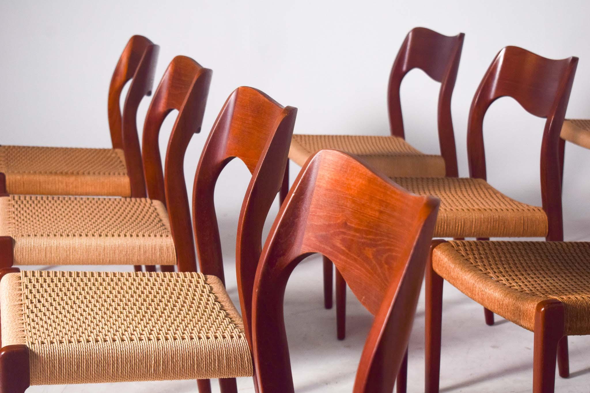 Niels O. Moller design, set of 12 dining chairs, model 71, teak, papercord upholstery, manufactured by J.L. Møller Mobelfabrik, Denmark, 1950s. The backs of the chairs features the iconic Møller waved back, showing subtle and beautiful lines curves.