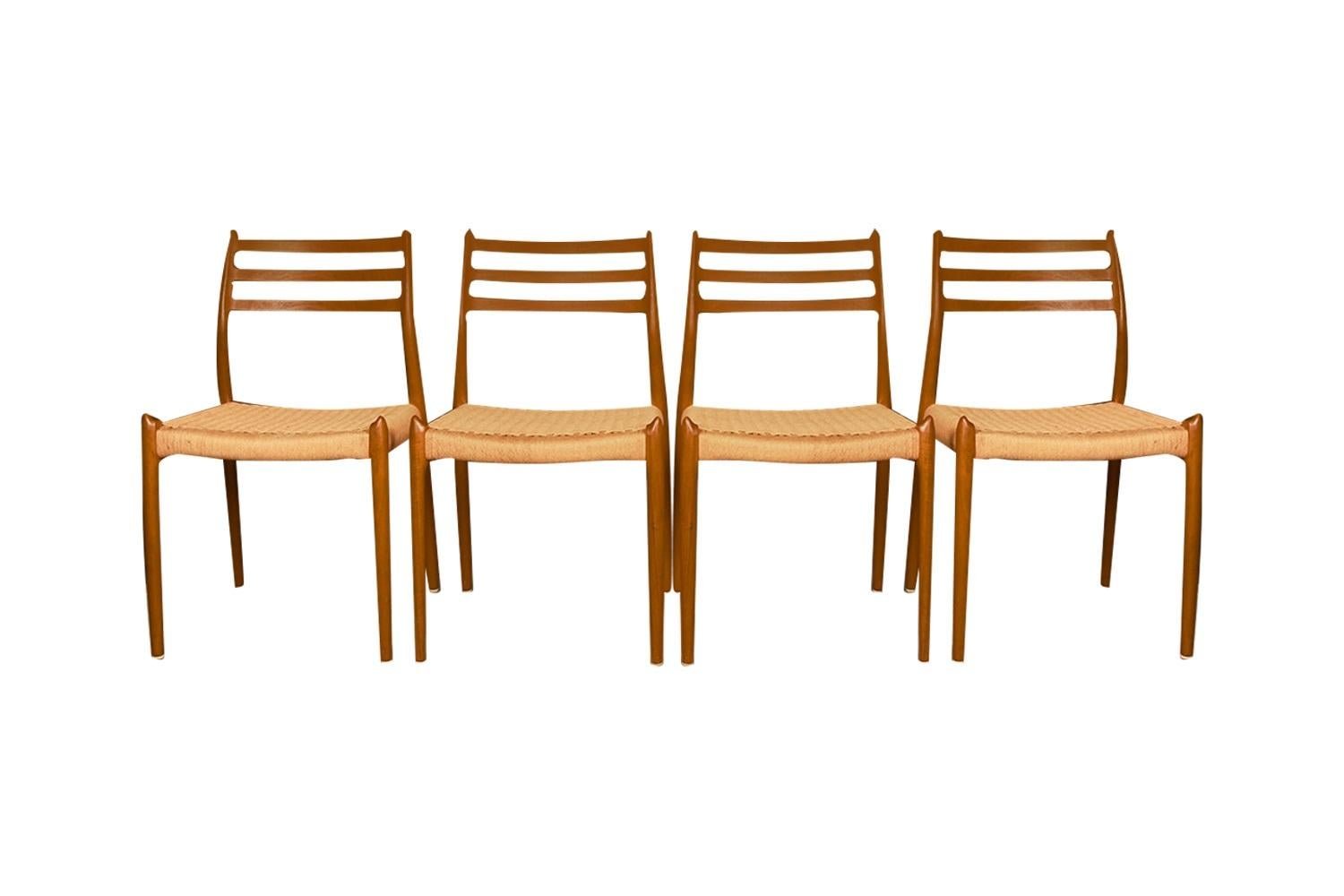 An absolutely stunning set of four Mid-Century Danish Modern dining chairs model 78 designed in 1962 by Niels Otto Moller for J.L. Møllers Møbelfabrik in Denmark. These gorgeous chairs feature beautifully sculpted teak frames and exquisite original