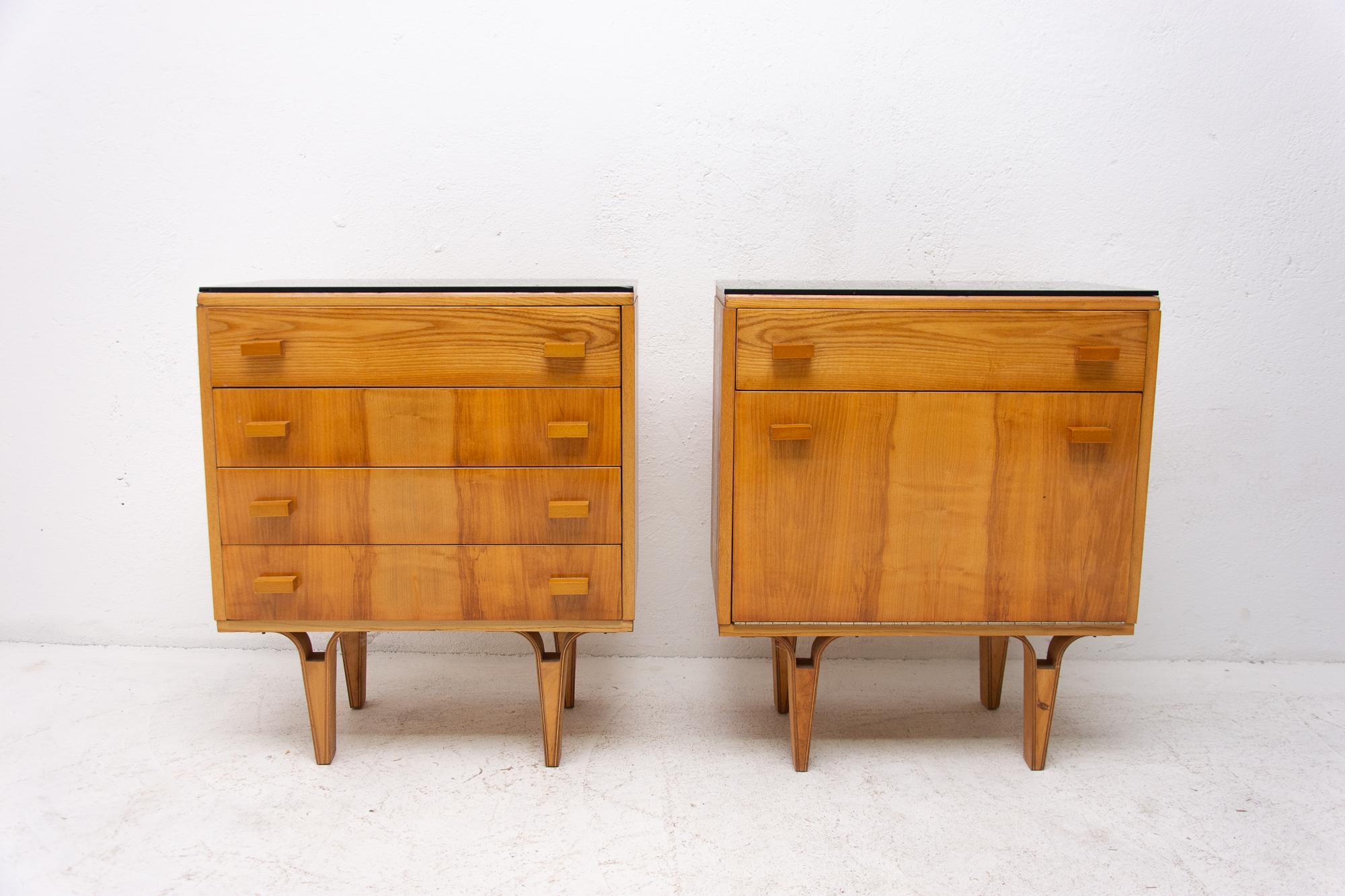 Made by furniture company “Nový Domov” in former Czechoslovakia in the 1970s.

These nightstands can be used also as a small chest of drawers. It features black glass at the top, one drawer and storage space at the bottom. Walnut veneer. Very