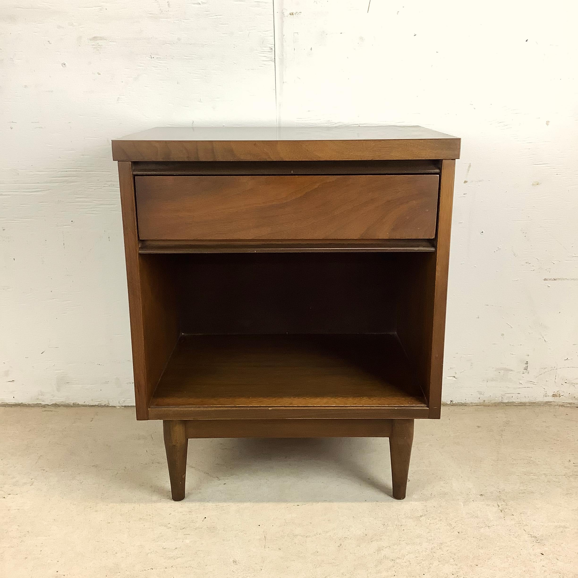 Introduce a touch of mid-century charm to your bedroom with this stylish Mid-Century Single Drawer Walnut Nightstand. Crafted with vintage walnut finish, this nightstand boasts a sleek silhouette and minimalist design that epitomizes the elegance of