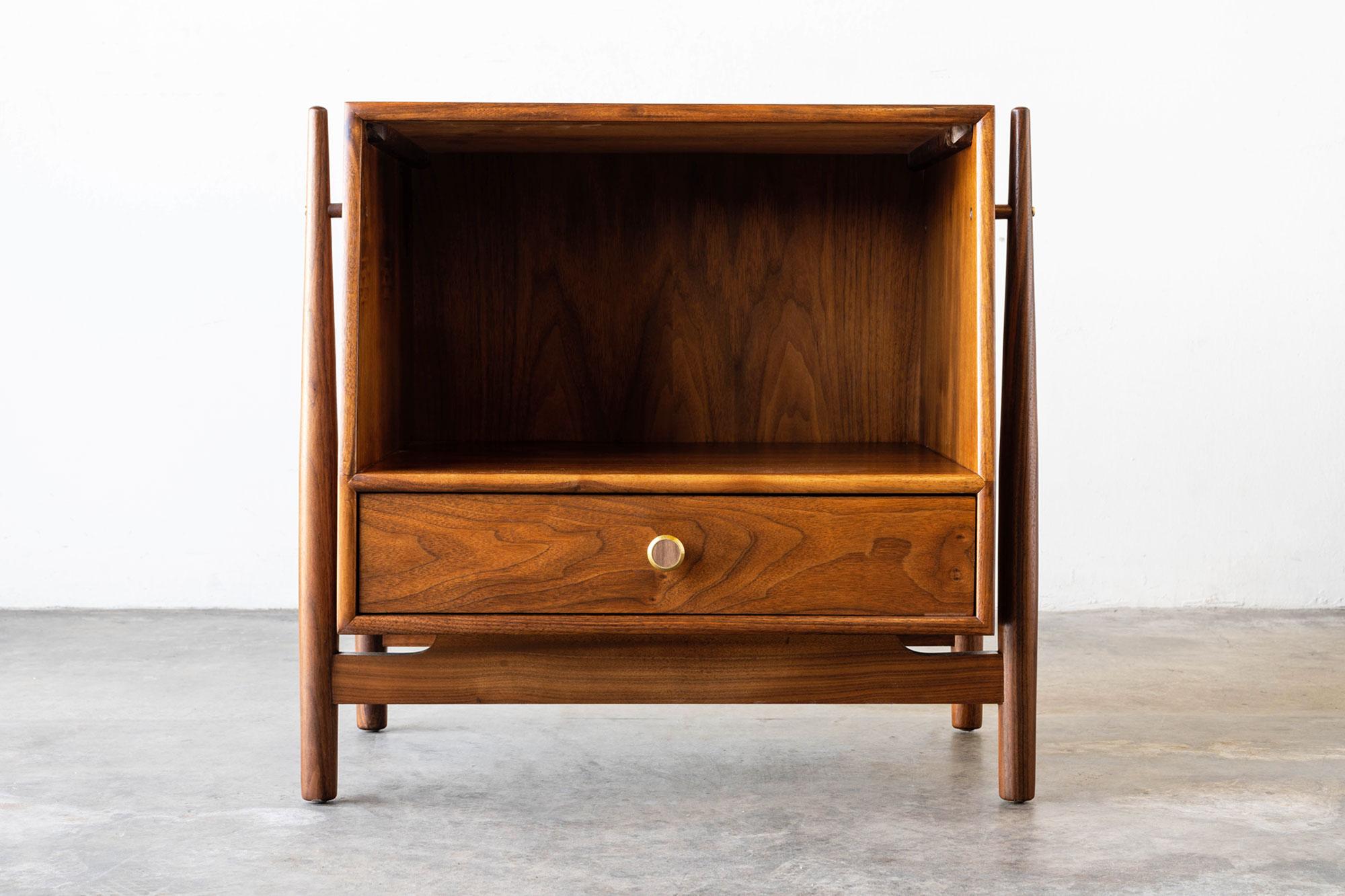 This Mid-Century Modern nightstand was designed by Kipp Stewart & Stewart MacDougall for Drexel's 'Declaration' line in the 1960s. The iconic 'Declaration' collection by Drexel features minimalist expressions and a straightforward design that is
