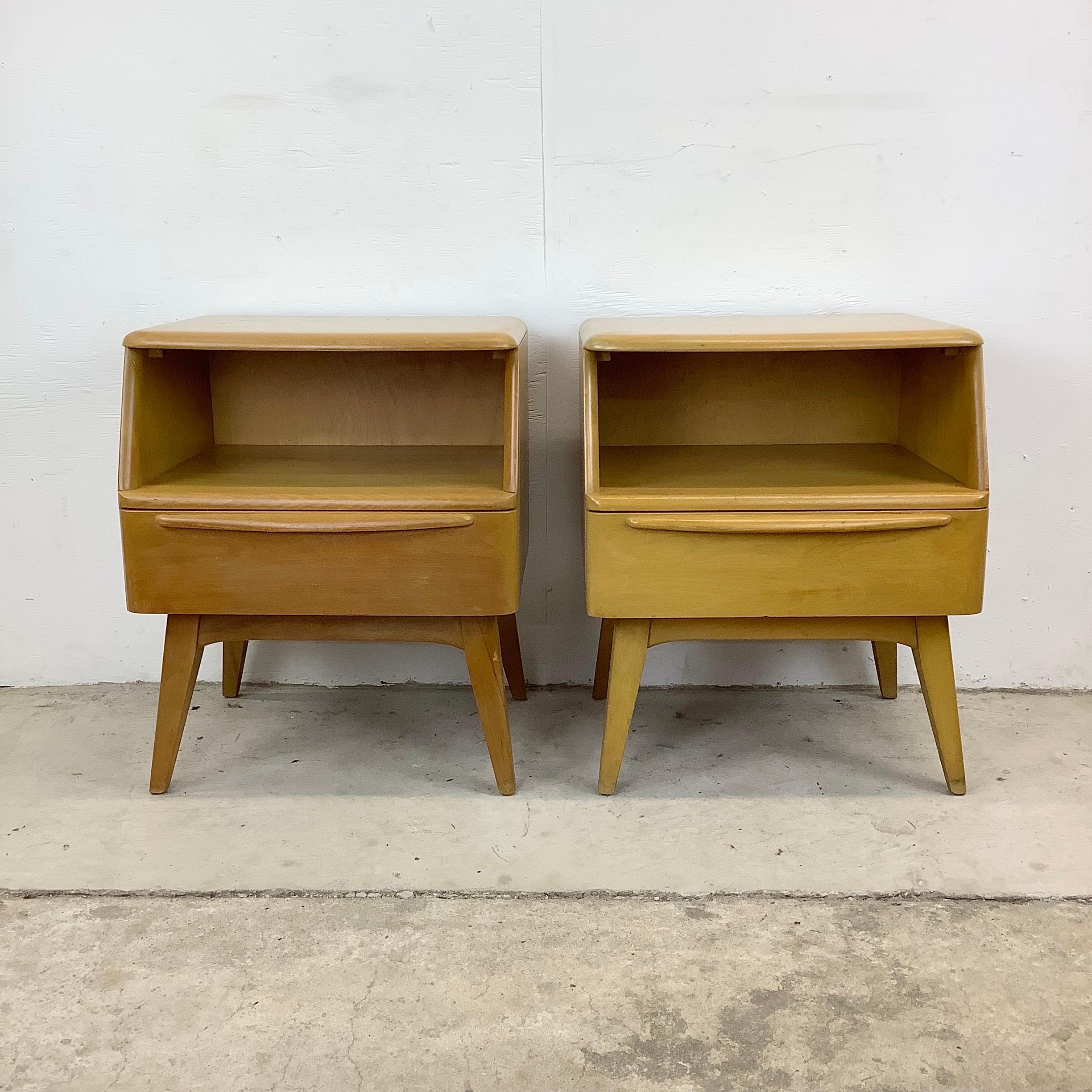 Mid-Century Heywood Wakefield Nightstands- a Pair

This stunning pair of matching nightstands feature solid birch finish and construction with unique mid-century design. The striking legs, sculpted wooden drawer pulls, open cubby storage, and