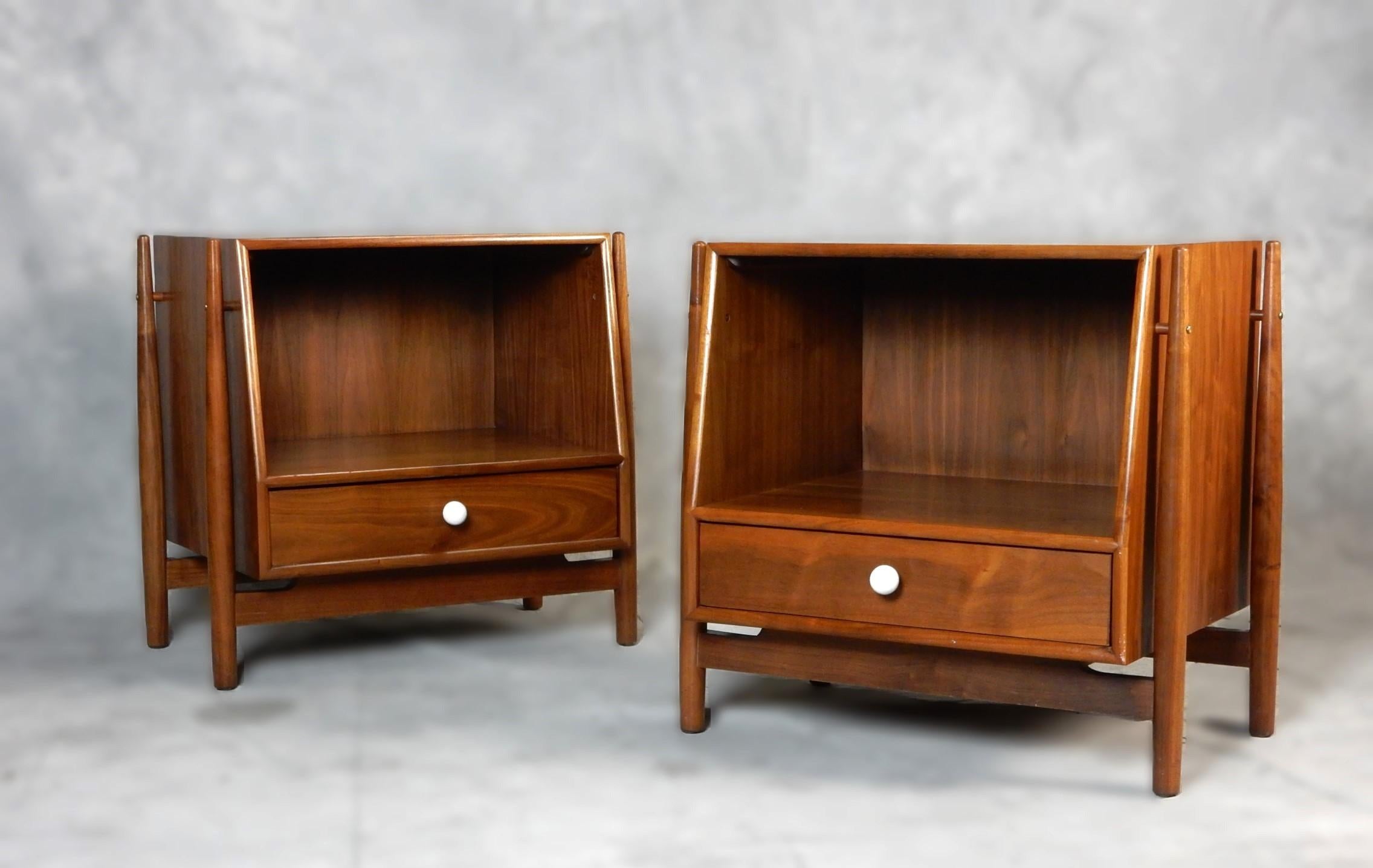 A pair of Mid-Century Modern nightstands designed by Kipp Stewart & Stewart MacDougall for Drexel’s ‘Declaration’ line, circa 1960s. 
Single lower drawer with iconic porcelain ball pull and a large open space to store books etc.
The geometric cases