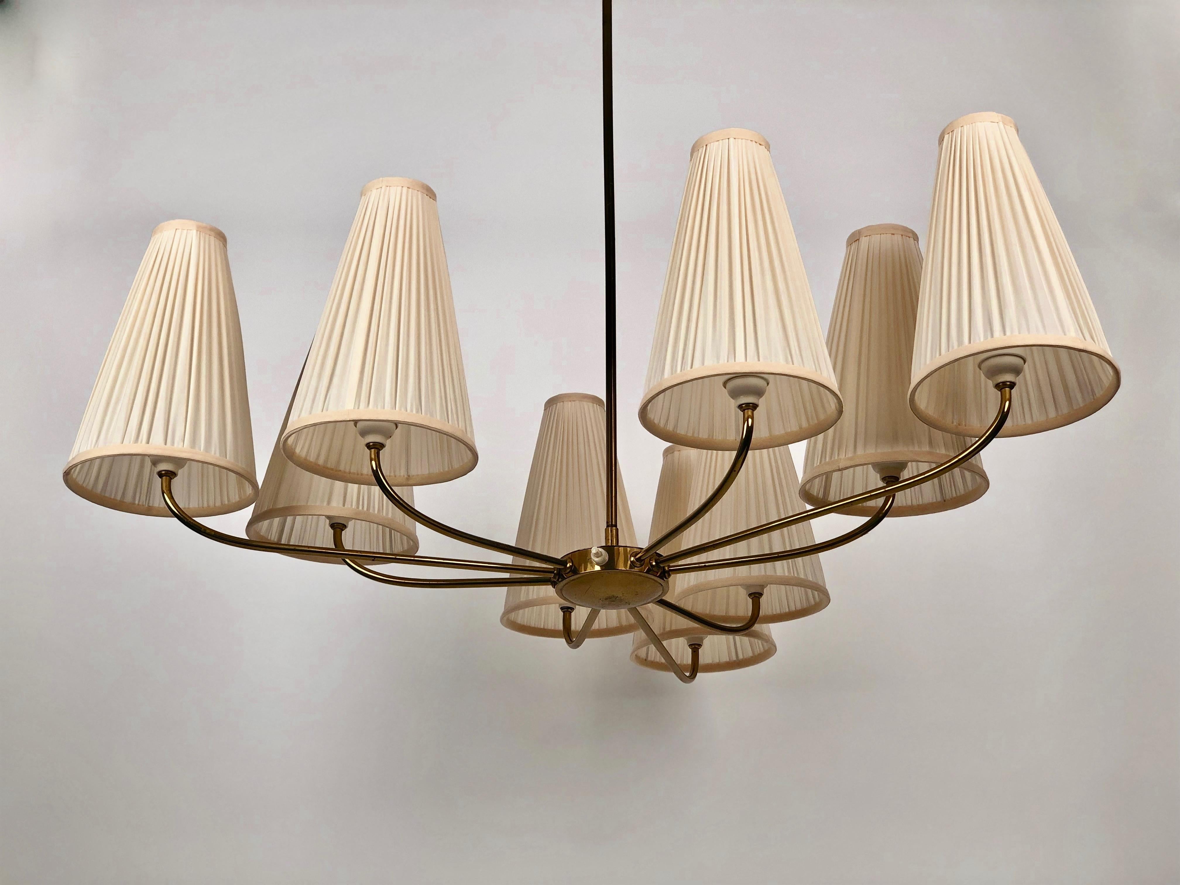 An unusual chandelier in oval form with nine brass arms and silk shades in cream colour. The shades are new based on the original forms.

The electric has been controlled.