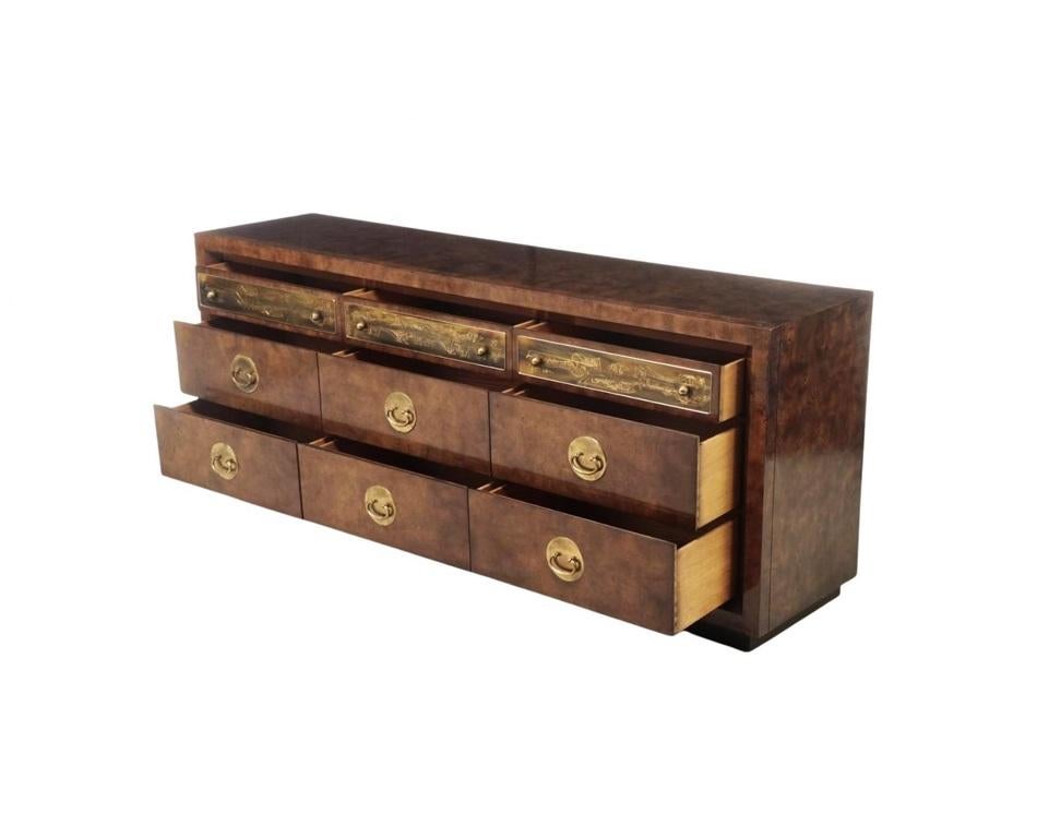This stunning mid-century modern triple dresser by Bernhard Rohne for Mastercraft, is simply incredible. Professionally refinished showcasing the gorgeous burled amboyna wood. It has nine drawers, the top three of which have etched and patinated
