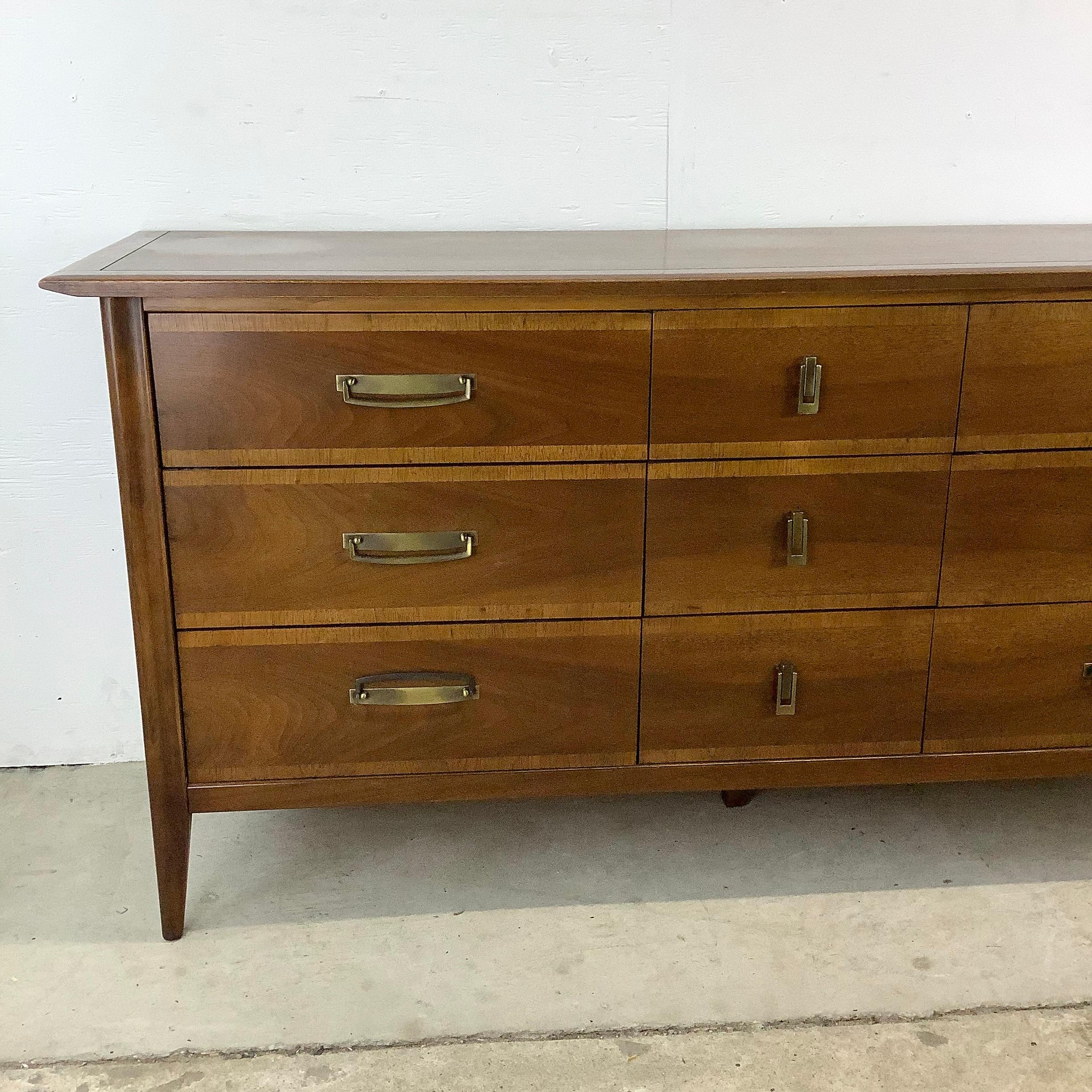 Discover the charm of this Vintage Nine-Drawer Lowboy Dresser by Stanley furniture, a stellar addition to any home seeking the elegance and sophistication of mid-century style. This piece isn't just a storage solution; it's a testament to timeless