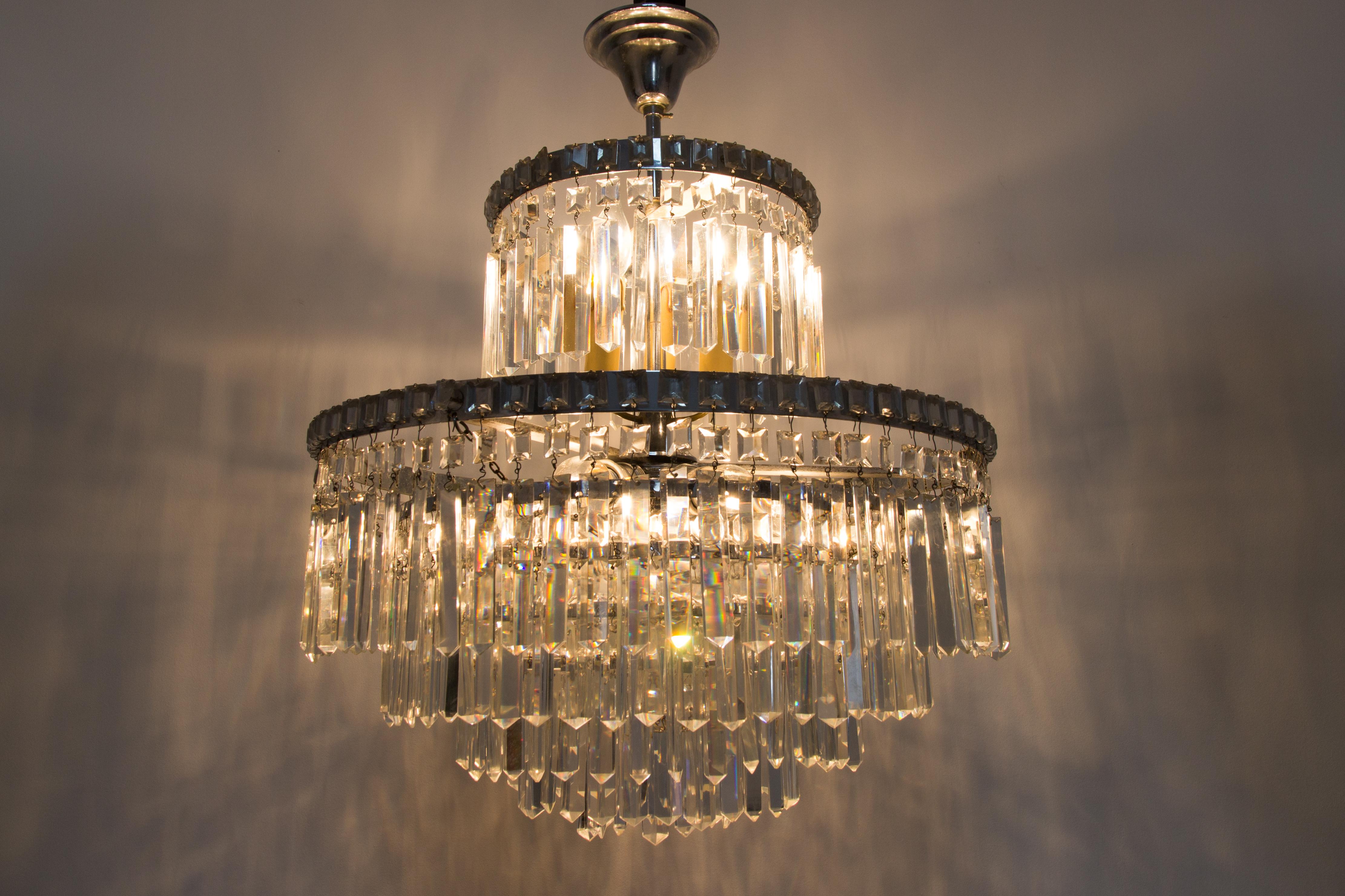 Beautiful Mid-Century five tier crystal chandelier, bronze frame. In total, the chandelier has 568 crystals, including: 219 large crystals, 14 medium sized crystals, 335 small crystals.
Nine original sockets with new wiring. Six sockets for E 27