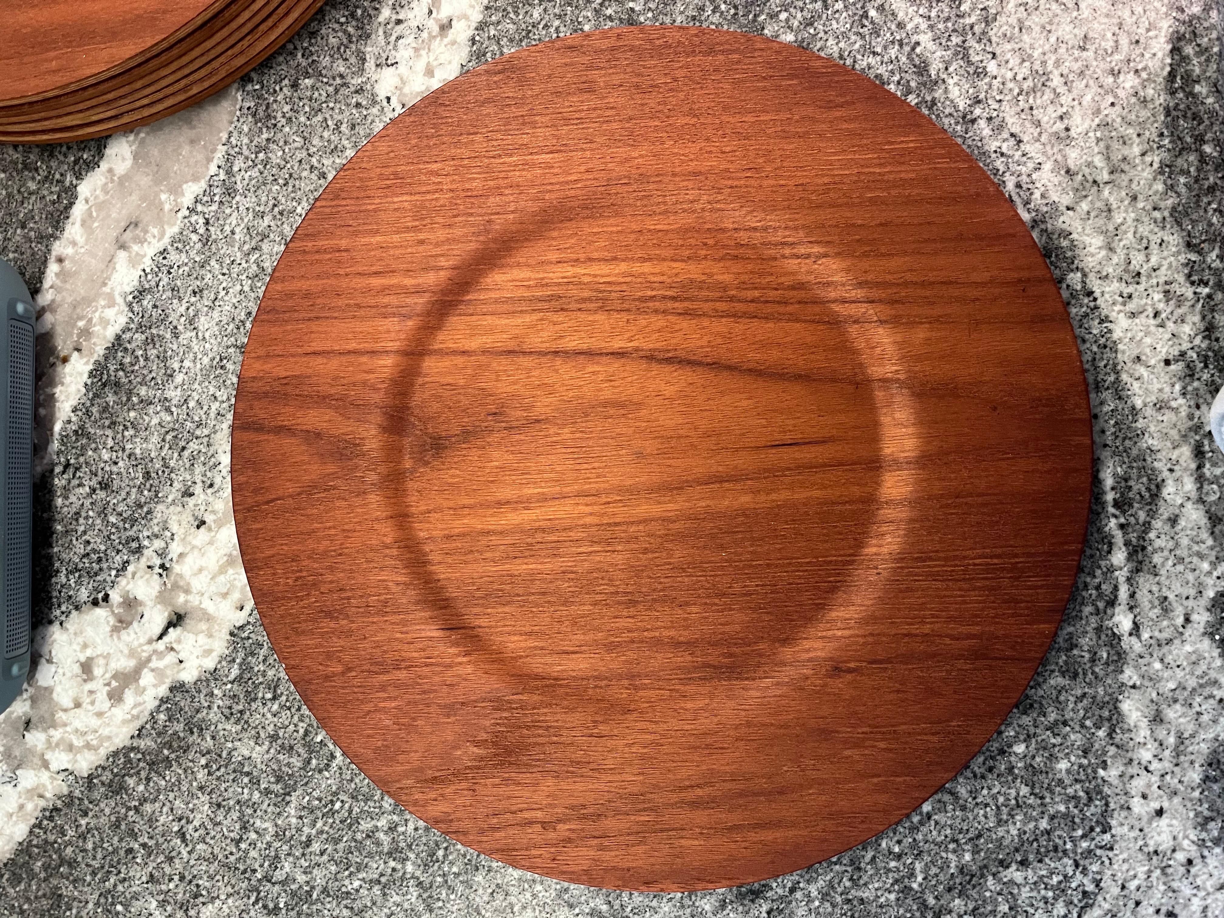 Set of 8 teak chargers or plates circa late 1960s. Nordika out of Sweden. These all original examples are in excellent vintage condition. Beautiful grain. Price listed is for the set of 8.