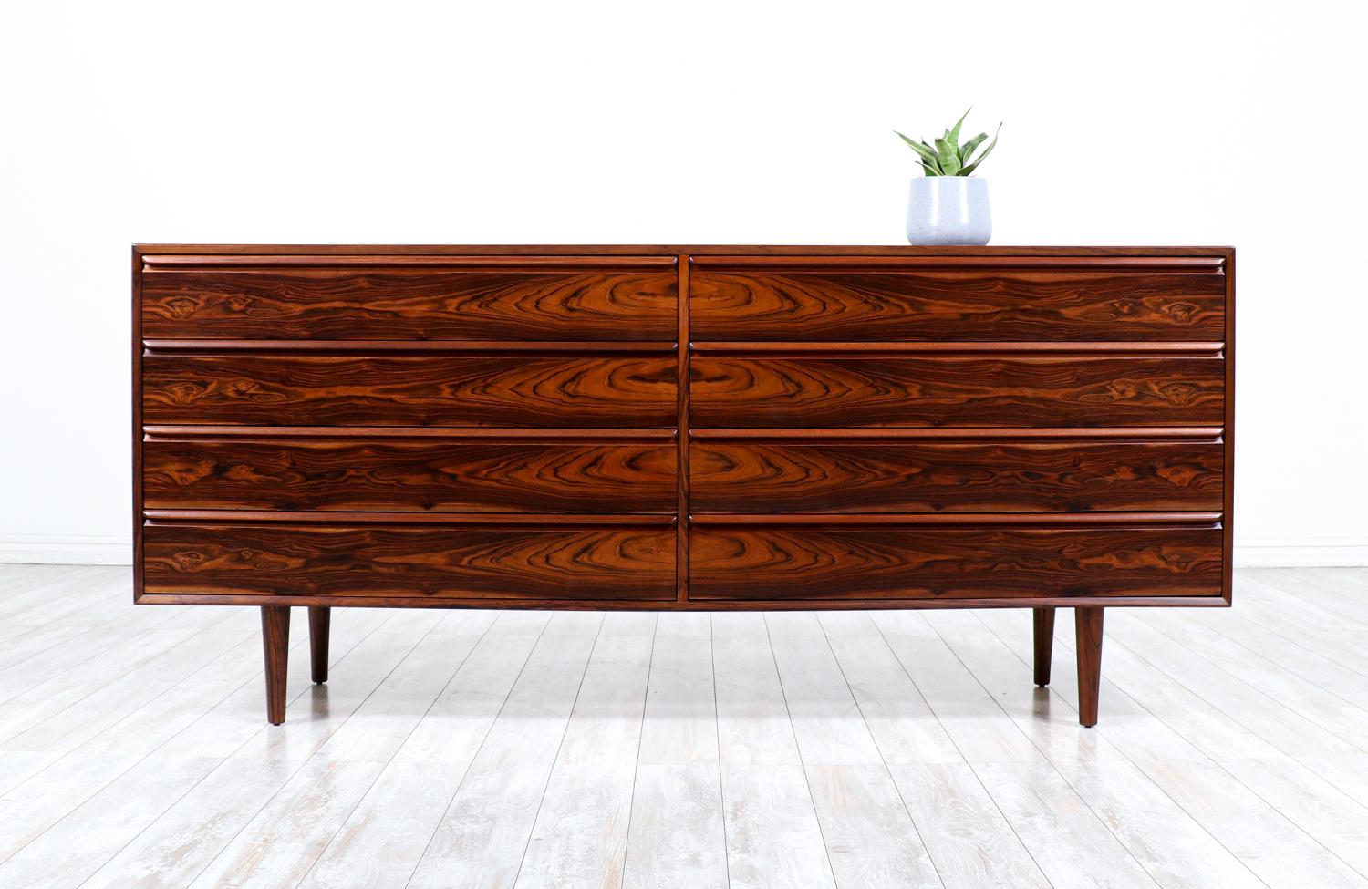 Elegant modern dresser designed and manufactured by Westnofa Furniture in Norway circa 1960s. This classic Norwegian minimalist design features an exotic Brazilian rosewood frame with eight dovetailed drawers. Each drawer is accented with Westnofa’s