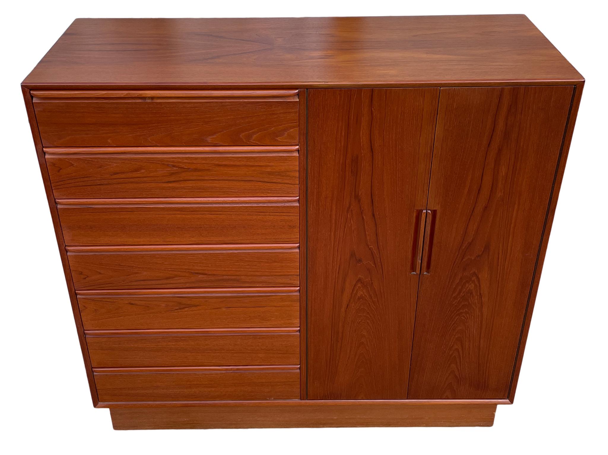 Beautiful mid-century Norwegian modern teak 14-drawer tall dresser Wardrobe by Westnofa. Great design and great vintage condition - clean inside and out. Drawers slide smooth with dovetail construction and carved handles with 2 cabinet doors.