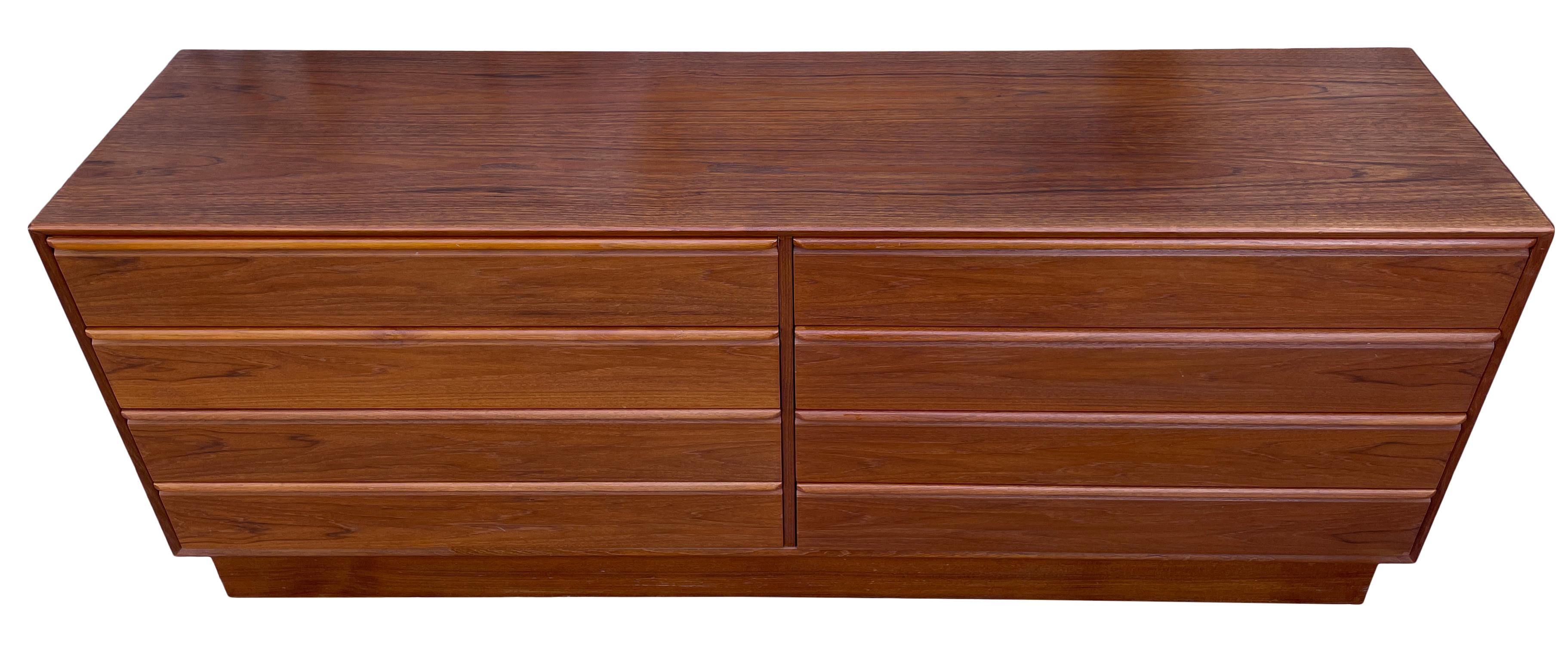 Beautiful Mid-Century Norwegian modern low teak 8-drawer dresser credenza by Westnofa. Great design and great vintage condition - clean inside and out. Drawers slide smooth with dovetail construction and carved handles. Stunning Wood grain. Shows