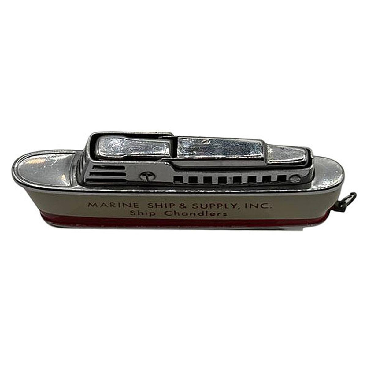 Mid-century Sarome 'Cruiser' lighter, shaped like a Cruise ship, features a chrome body enameled red and crème accents and 