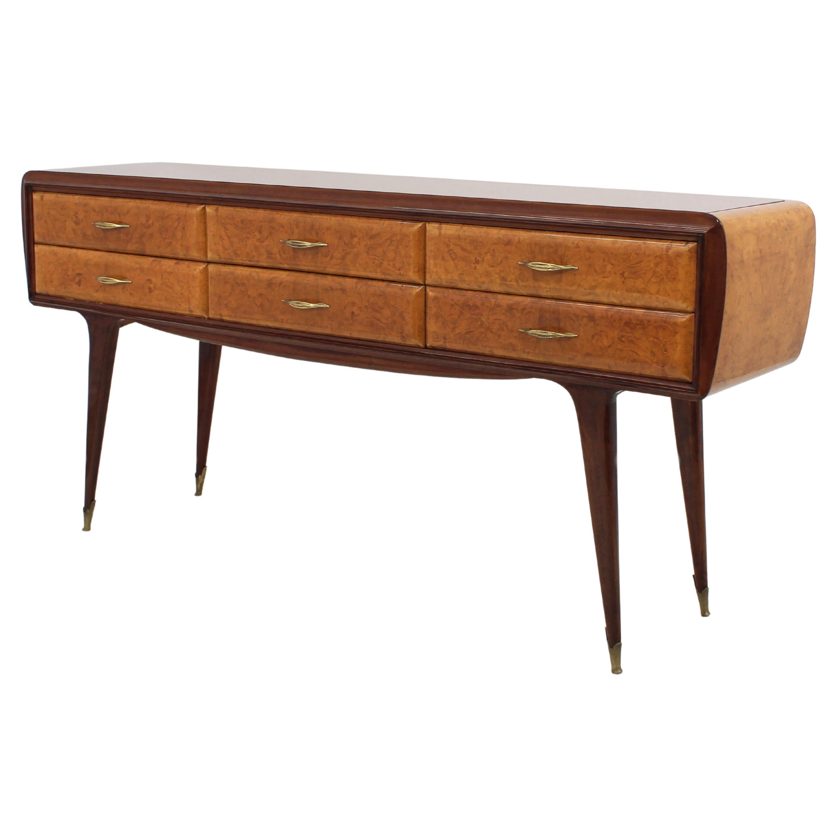 Restored wooden sideboard with spiked feet, six drawers, with briar coverings and glass top. Captivating curved profiles, abstract linear decorations on the burl of the rounded drawers and beautiful champaigne-colored top with relief motifs, with