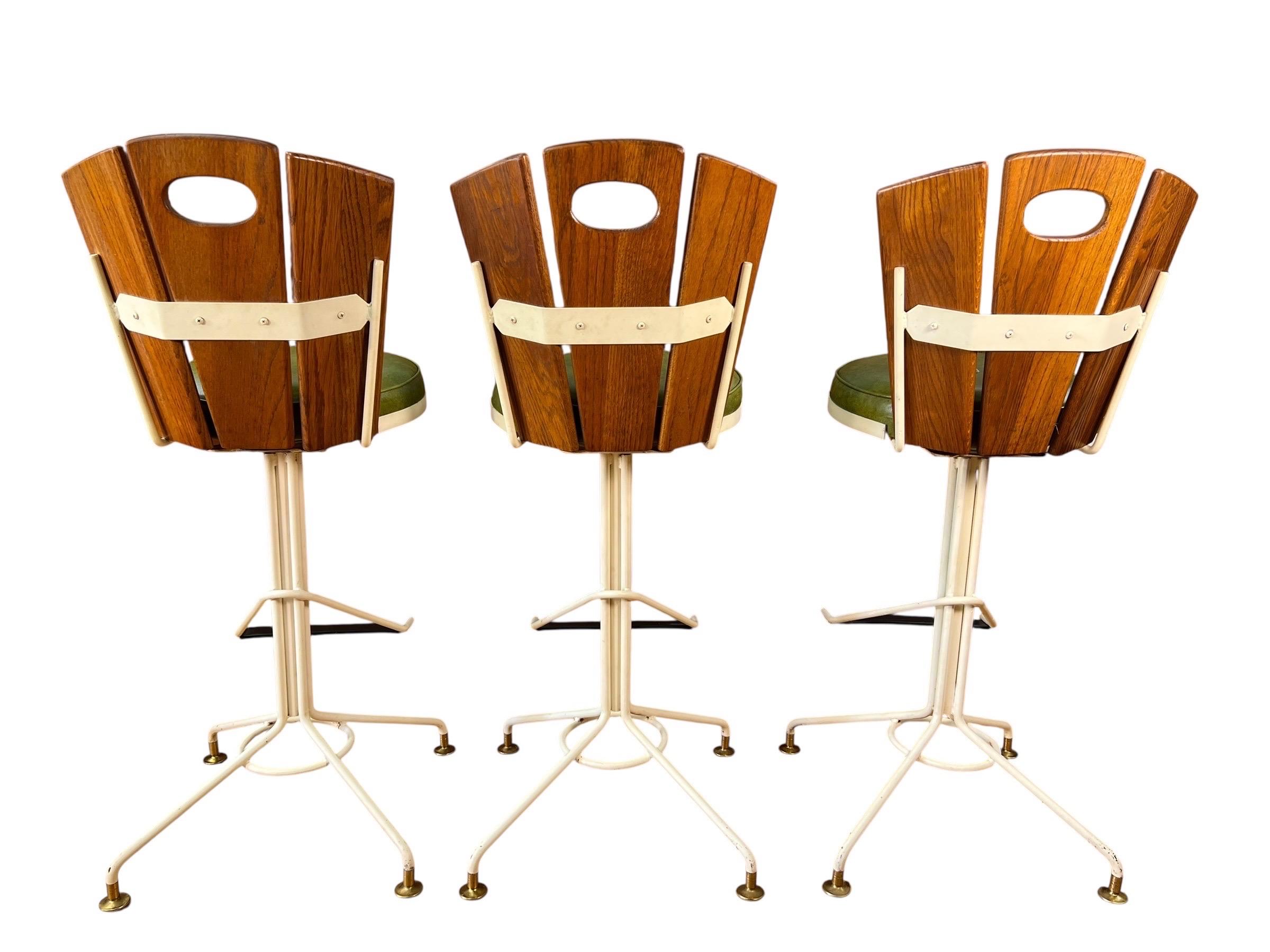 Mid Century Oak and Cast Iron Swivel Bar Stools - Set of 3 In Good Condition For Sale In Esperance, NY