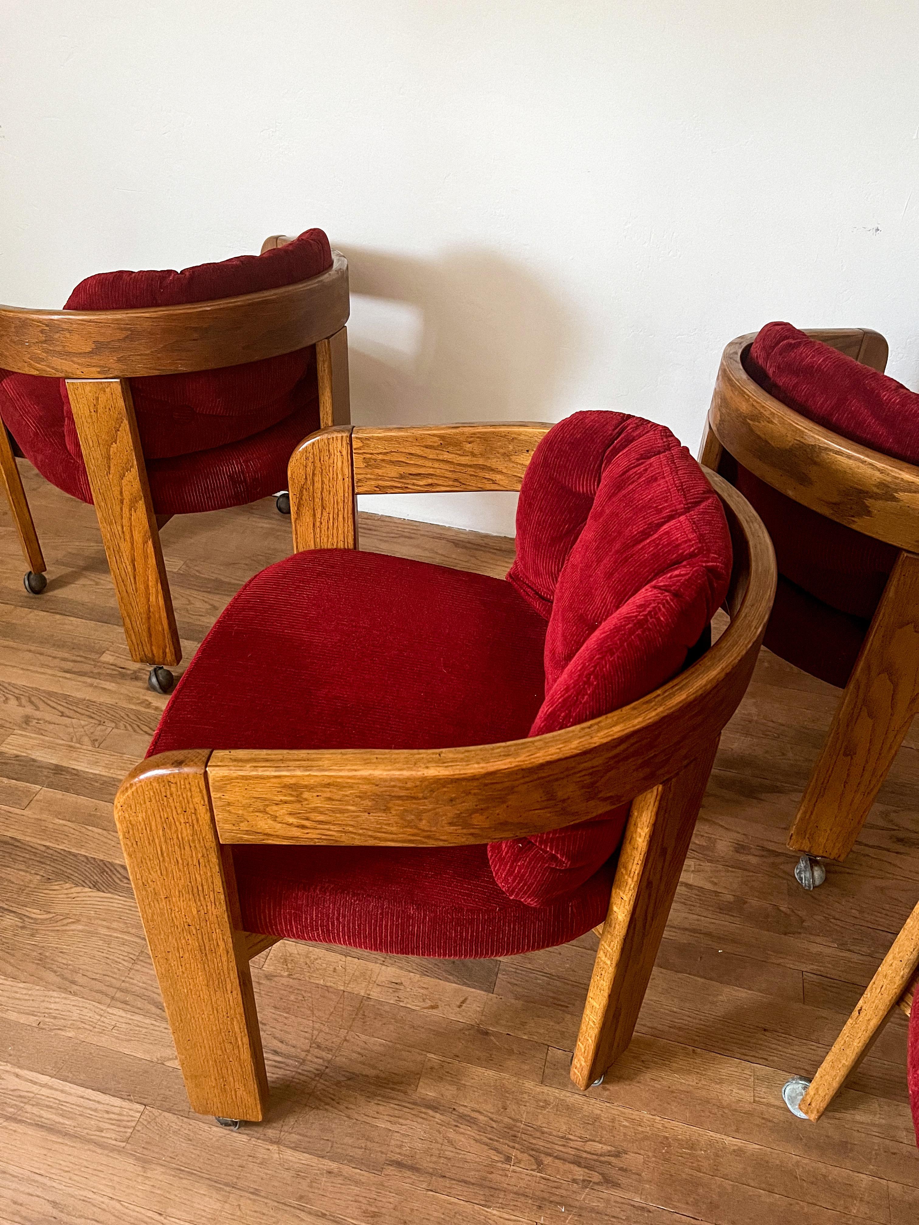 Set of 4 barrel dining chairs in casters. Circa 1970s. Chairs feature an oak frame and original burned red corduroy upholstery in excellent vintage condition.

Barrel style reminiscent of Tobia Scarpa’s Pigreco Chair.

All chairs come with a back