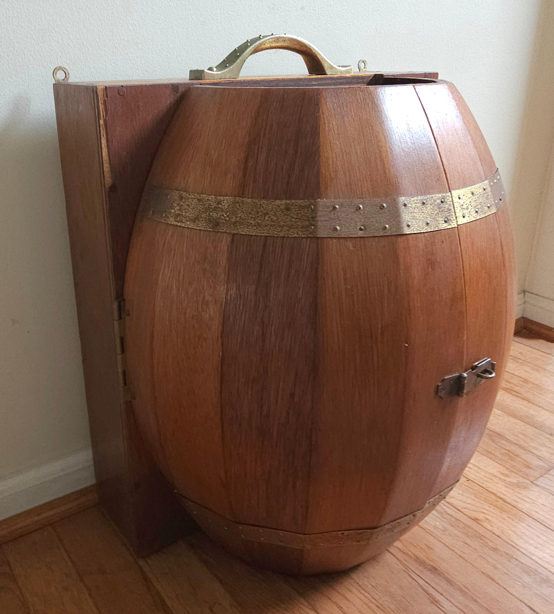 A Mid-Century Oak Barrel Wall Hanging Liquor Bar with a Collection of 11 mostly Gold Banded Glasses. Measures 16.25